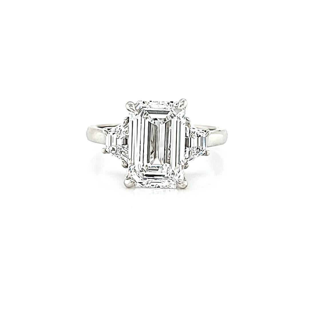 Center stone is a 3.01 carat Emerald Cut Diamond. GIA certified D color and VS2 clarity. 1.54 Length to Width Ratio makes this a nice rectangular stone. Not to short to look square and not to long that it looks more like a baguette Diamond. Set in a