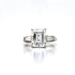 Louis Newman & Co GIA certified 3.51 carat Emerald Cut Diamond Three Stone Ring