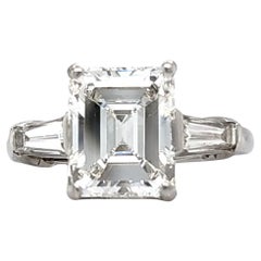 Louis Newman & Co GIA certified 3.51 carat Emerald Cut Diamond Three Stone Ring