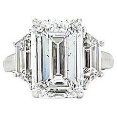 Louis Newman 
Co GIA Certified 5.05 Carat Emerald Cut Diamond Three Stone Ring
