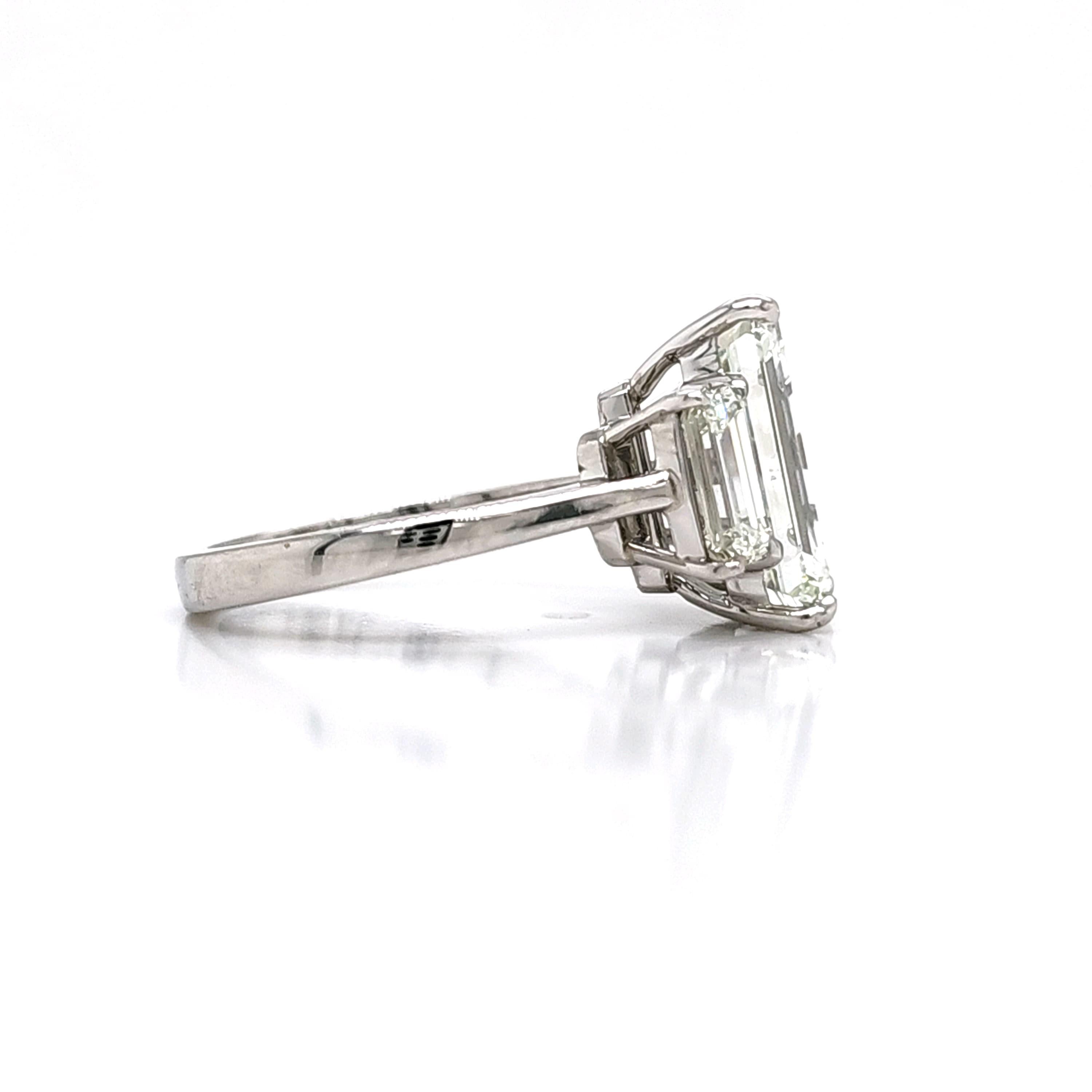 Louis Newman & Co GIA certified 5.11 carat Emerald Cut Diamond Three Stone Ring For Sale 1