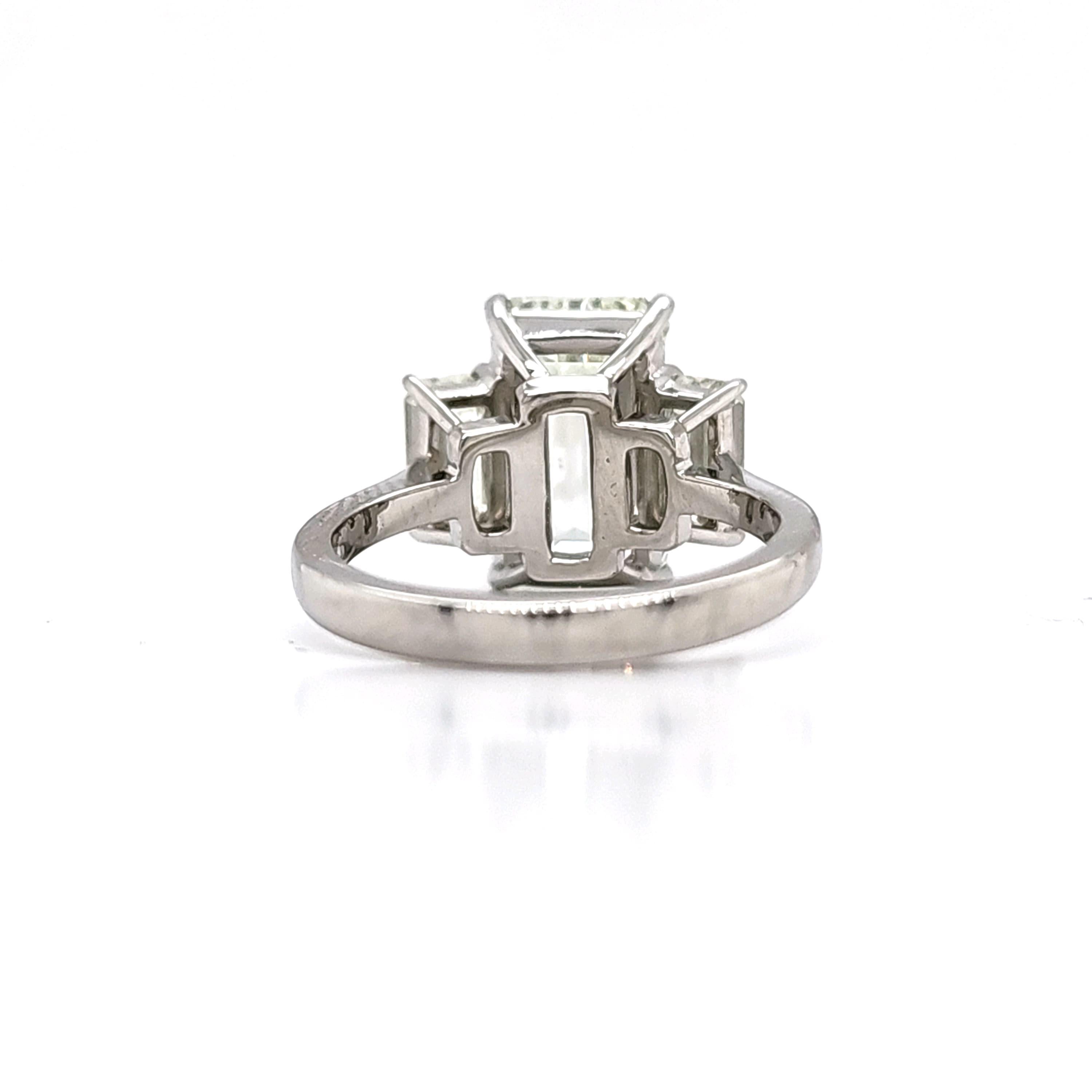 Louis Newman & Co GIA certified 5.11 carat Emerald Cut Diamond Three Stone Ring For Sale 2