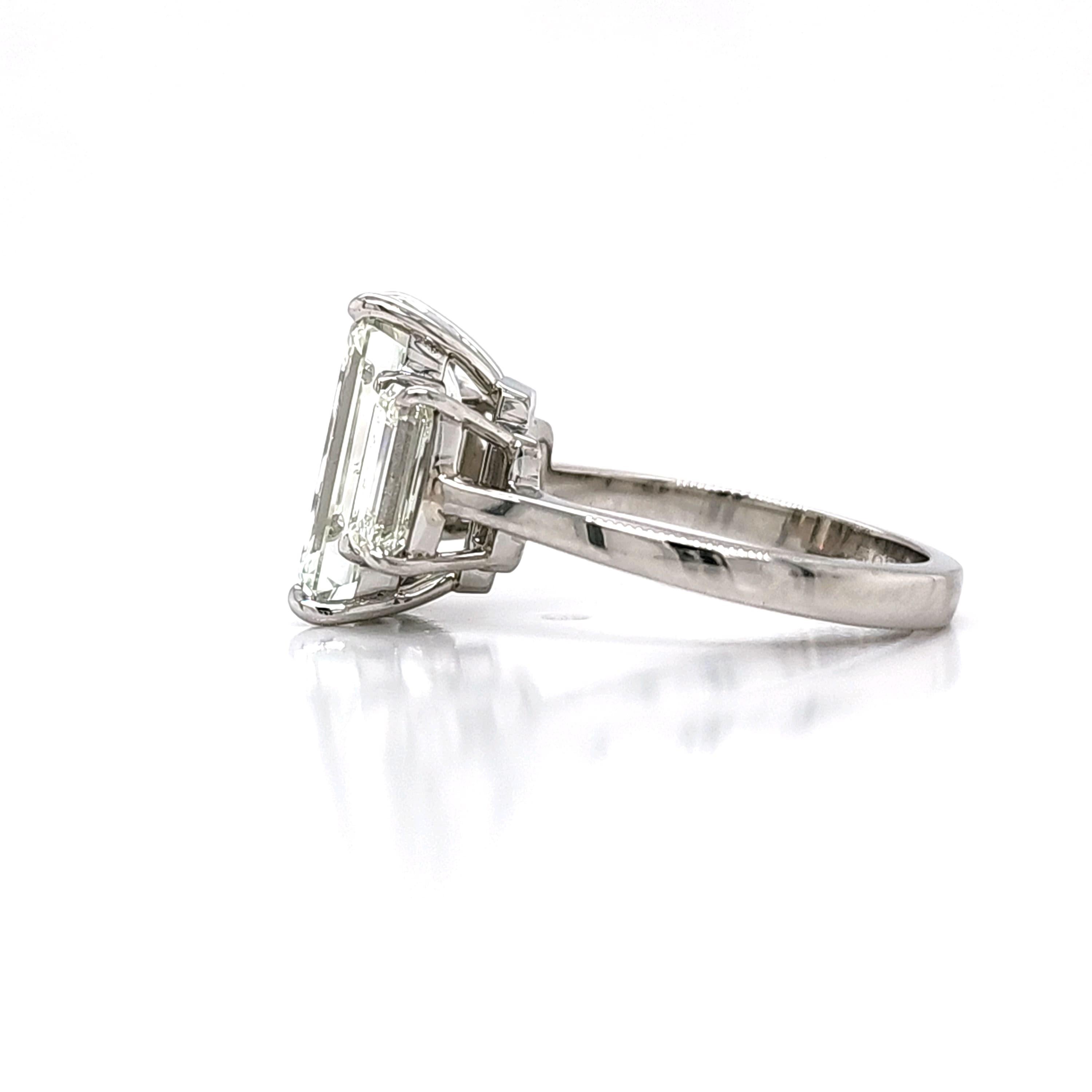 Louis Newman & Co GIA certified 5.11 carat Emerald Cut Diamond Three Stone Ring For Sale 3