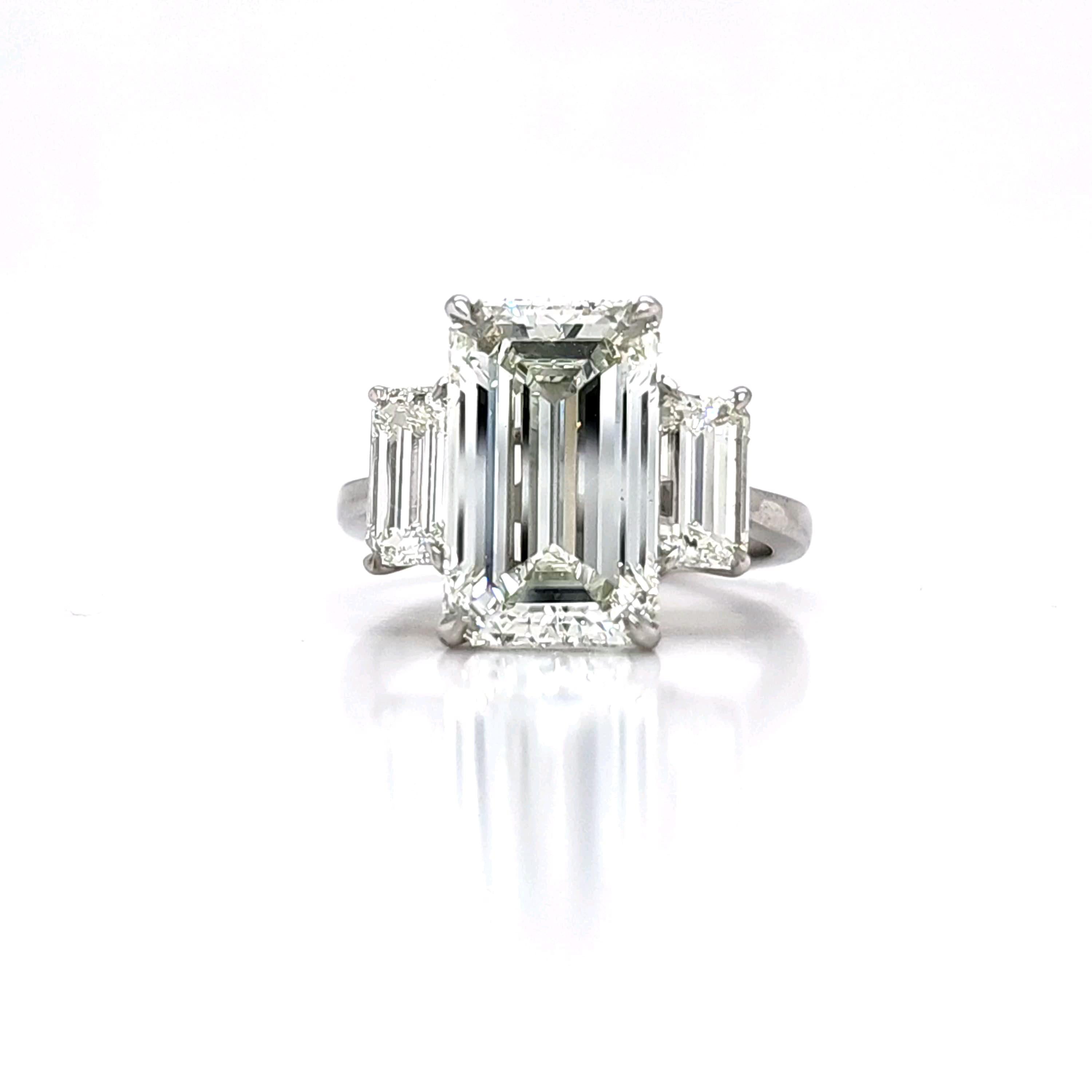 Louis Newman & Co GIA certified 5.11 carat Emerald Cut Diamond Three Stone Ring For Sale 4
