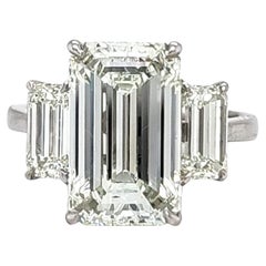 Louis Newman & Co GIA certified 5.11 carat Emerald Cut Diamond Three Stone Ring