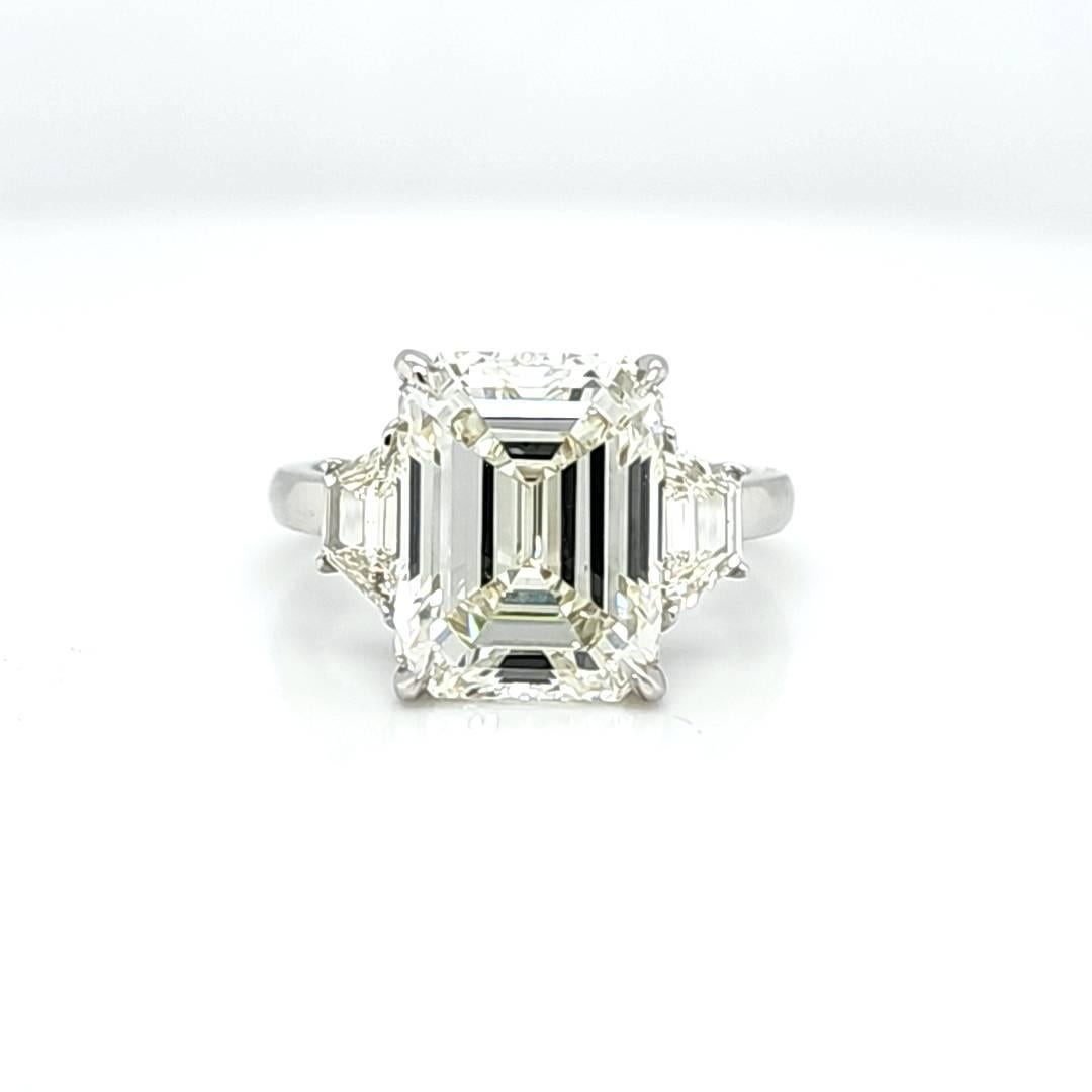 Center Stone is 6.11 Carat GIA certified Emerald Cut with an L color and VVS2 Clarity. It is very hard to capture the true color of the diamond but it does look better in person than it does int the photos. This is more of a classical shaped Emerald