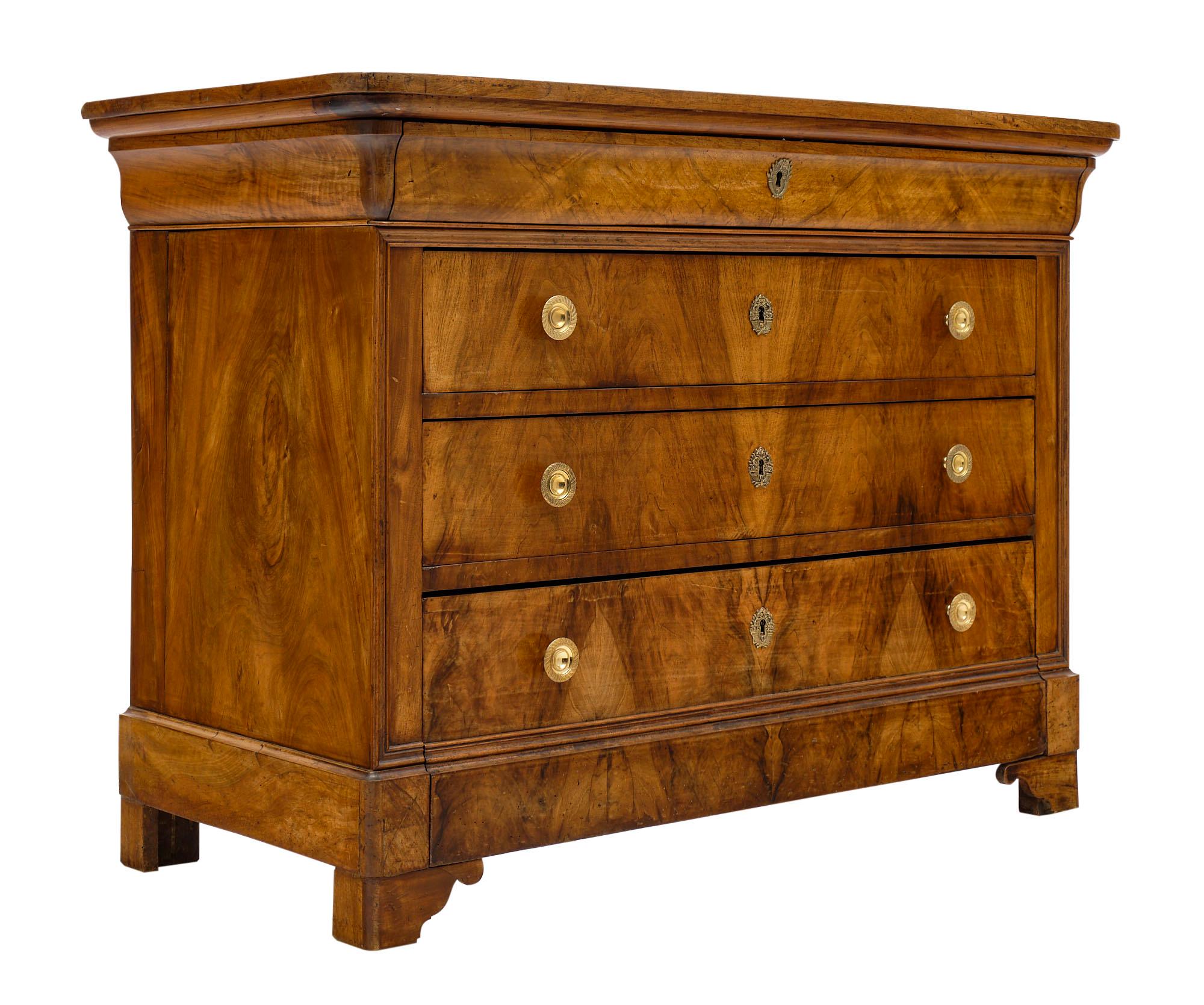 Louis Philippe antique French chest of drawers or “commode” made of solid blond walnut from the Rhone valley. The craftsmanship combines the burled and figured walnut for beautiful decorative impact. There are four dovetailed drawers to provide