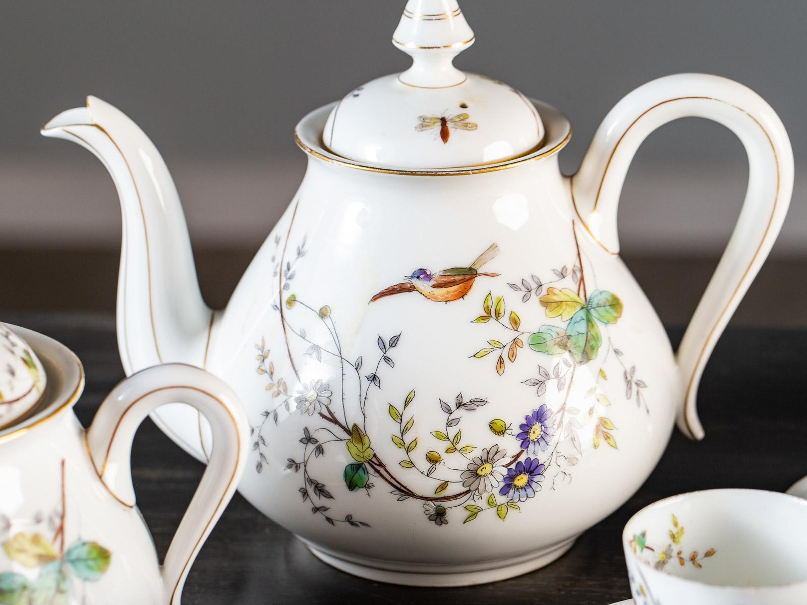 This hand painted Louis Philippe period fine porcelain antique French tea set has the most exquisite and delicate details. Please notice the assymmetrical placement of the flowers and insects across the surface of the porcelain. Each cup not only