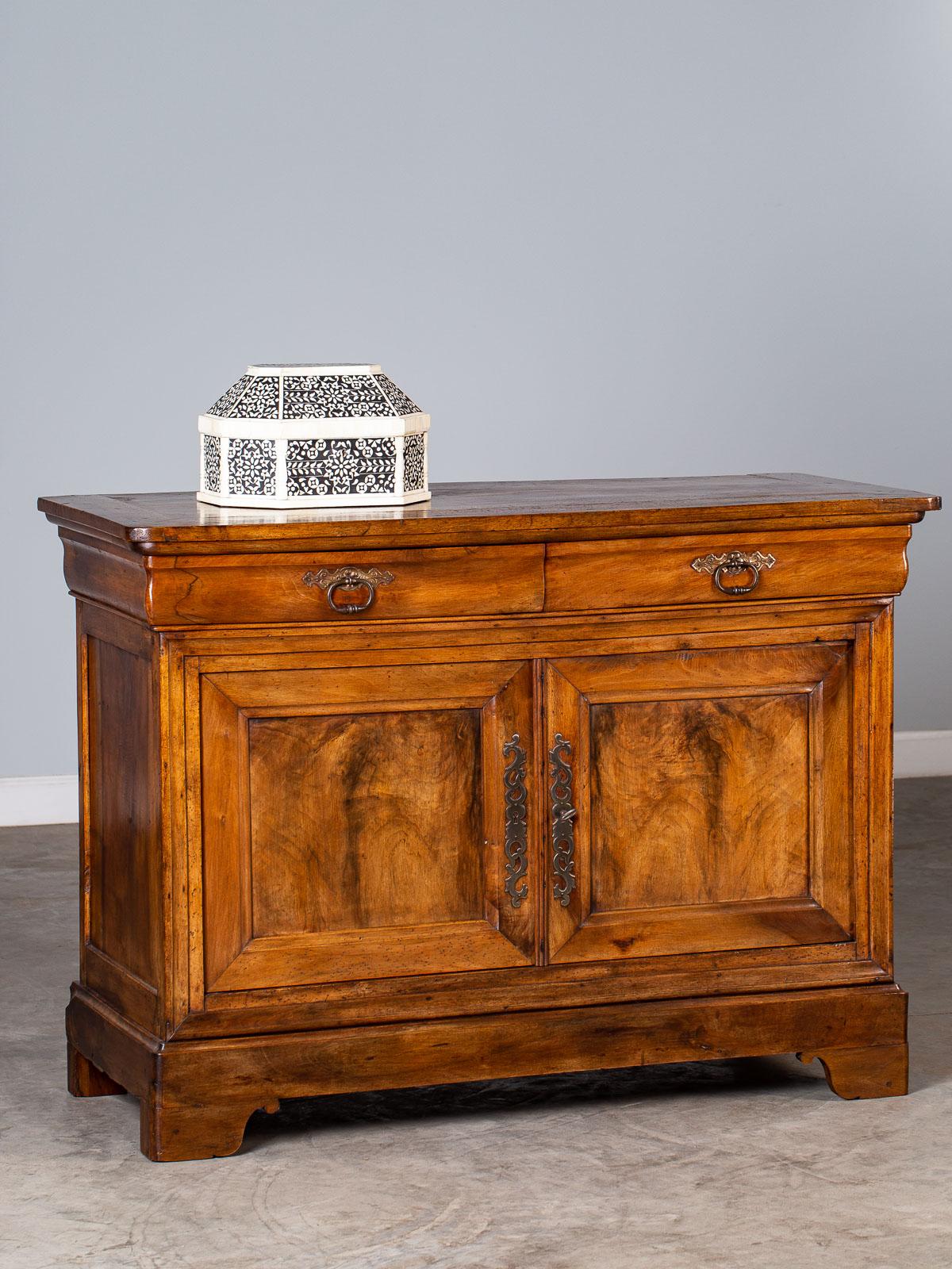 An excellent Louis Philippe antique French walnut buffet circa 1850 with two drawers above two cabinet doors. The clean lines of the Louis Philippe period in France (1830-1848) remains totally modern in its simplicity. The best Louis Philippe