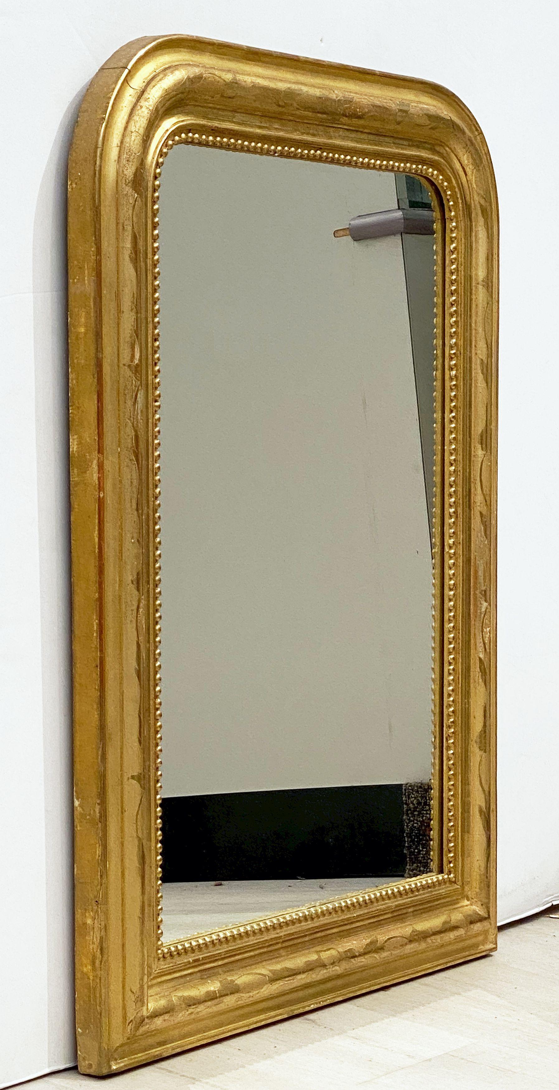 A handsome Louis Philippe gilt wall mirror featuring a lovely moulded surround with an etched foliate design showing through gold-leaf.

Dimensions: H 30 inches x W 22 3/4 inches

Other sizes available in this style.