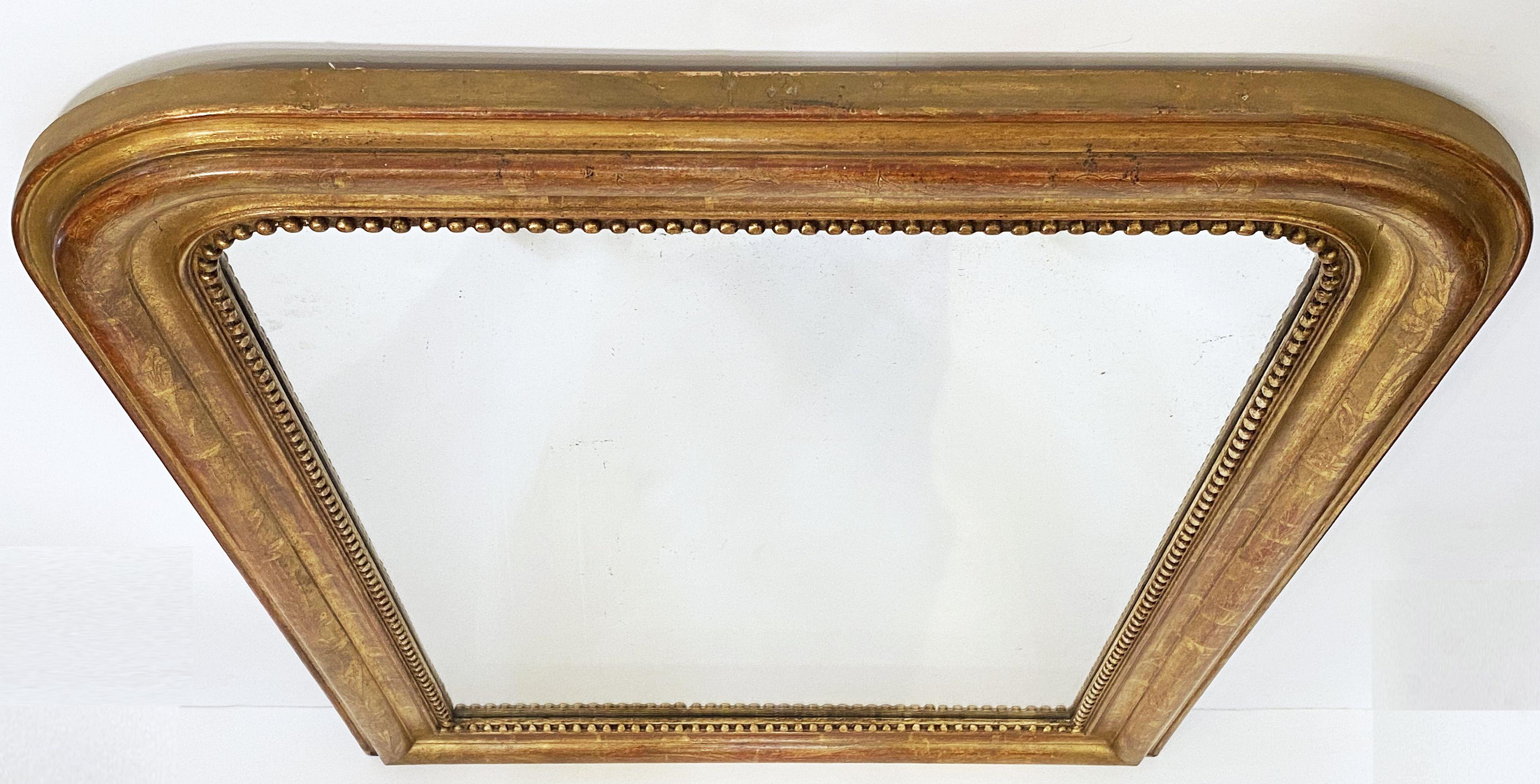 A handsome large Louis Philippe gilt wall mirror from France, featuring a lovely moulded surround and an etched foliate design showing through gold-leaf.

Dimensions: H 39 1/2 inches x W 28 3/4 inches

Other sizes available in this style.