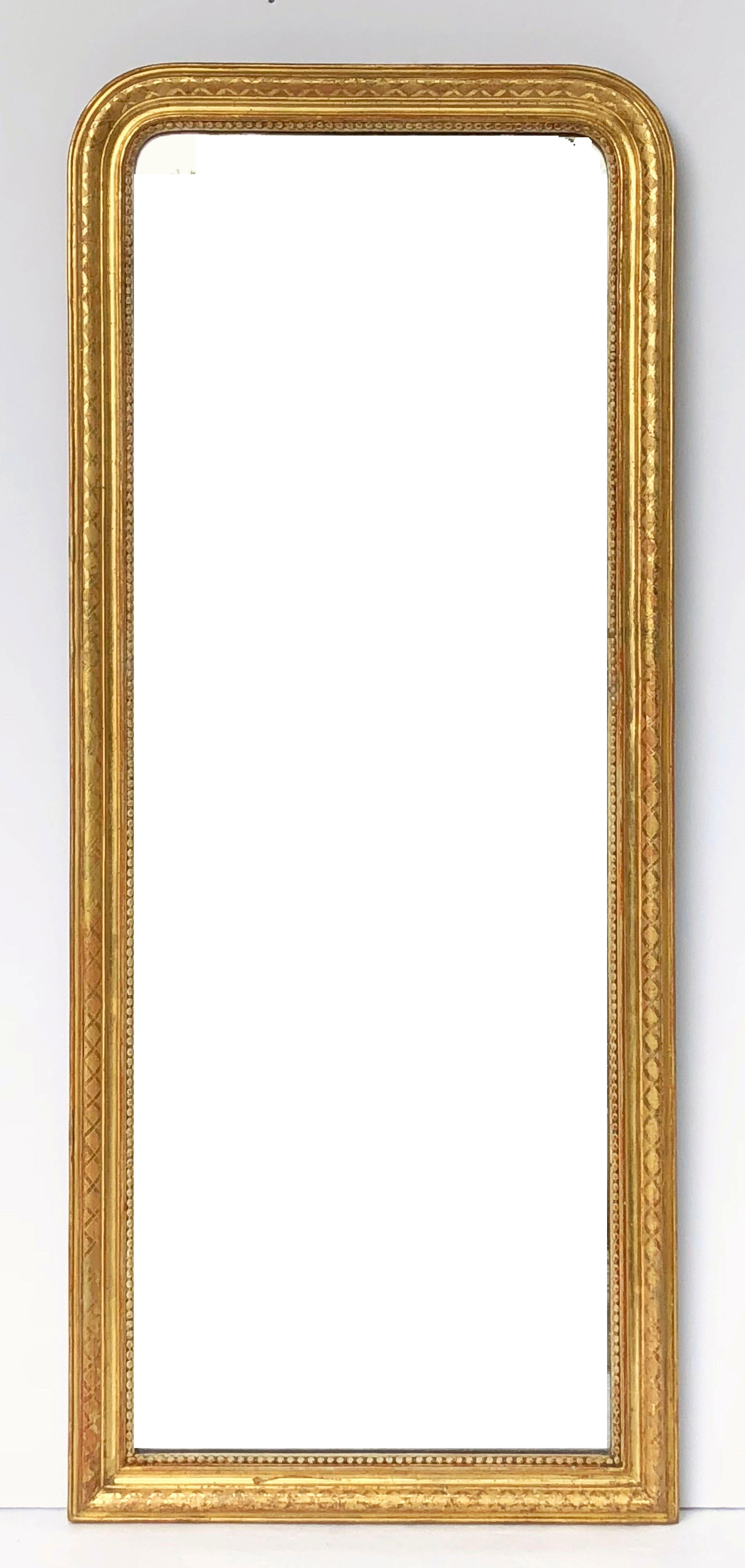 A fine tall Louis Philippe wall mirror from France, featuring a moulded surround with a beautiful patinated gold-leaf.

Dimensions: H 46 3/4 inches x W 19 5/8 inches

Other sizes available in this style.
   