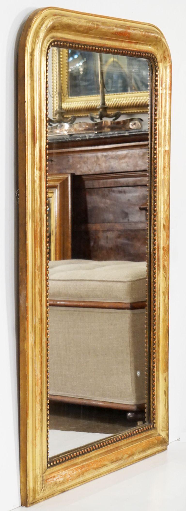 A fine Louis Philippe arch top wall mirror from France, featuring a moulded surround with a beautiful patinated gold-leaf.

Dimensions: H 49 1/4 inches x W 28 3/4 inches

Other sizes available in this style