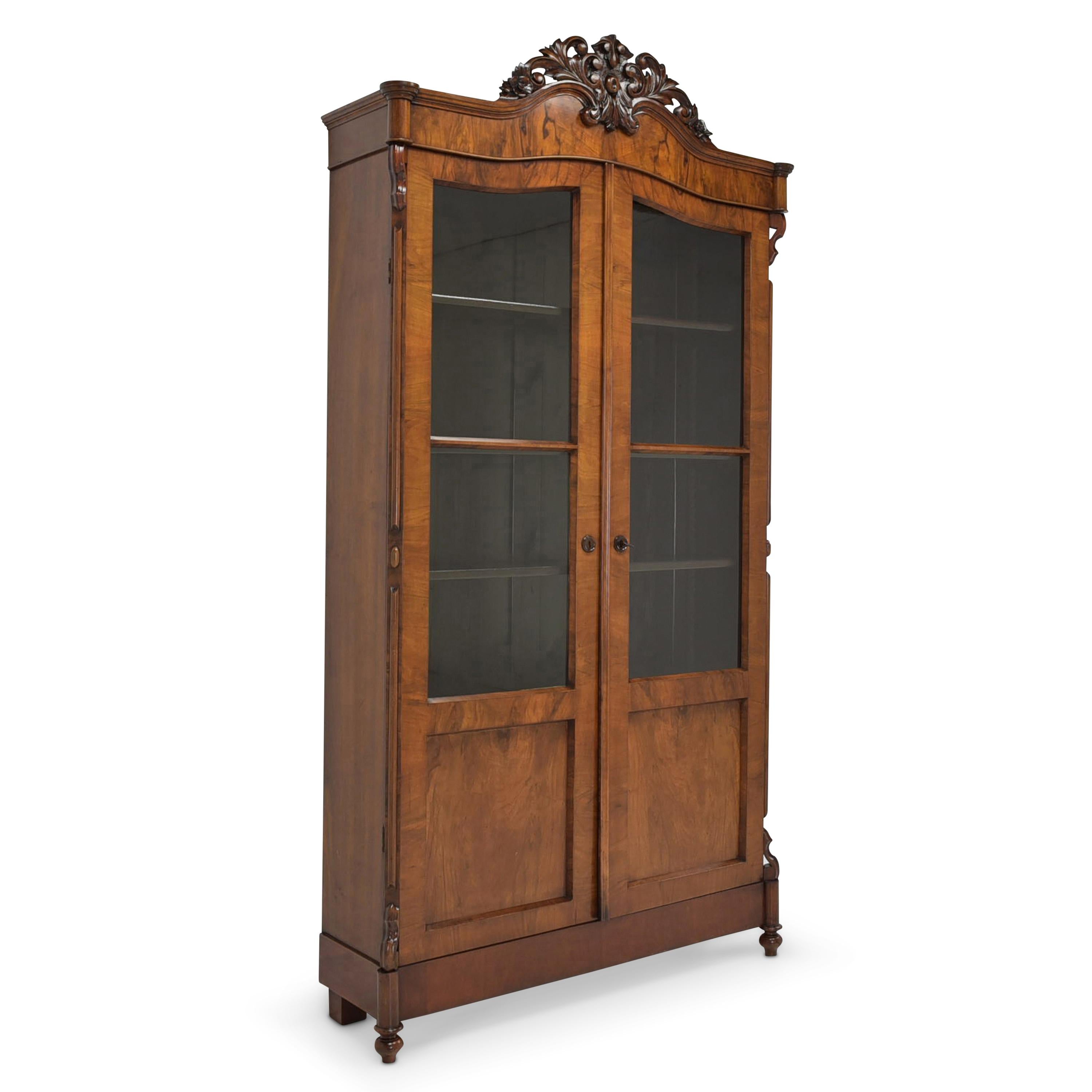Bookcase restored Louis Philippe around 1870 walnut display cabinet

Features:
Two-door model with 5 shelves
Massive shelves adjustable in height
Original glazing
Elaborately carved crown
Very nice grain
Very flat model (low depth)
The