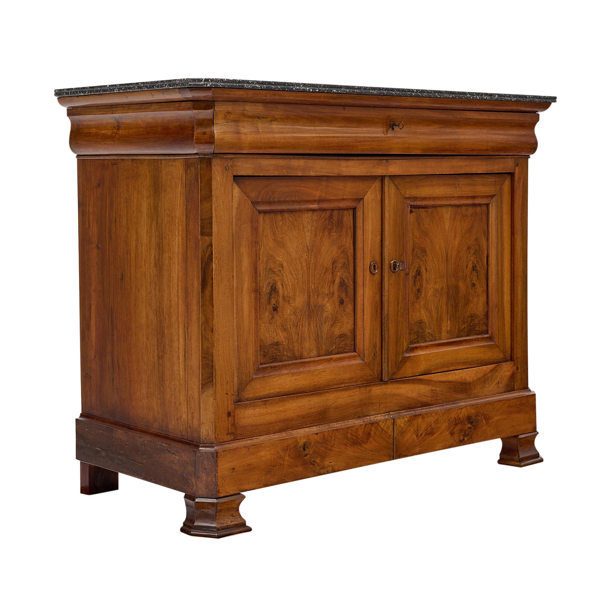 Buffet, French, from the Louis Philippe period. This piece is made of blond burled walnut book matched on the door panels and the bottom traverse, and solid blond walnut. It is from the Rhone Valley. The single drawer is dovetailed and softened by