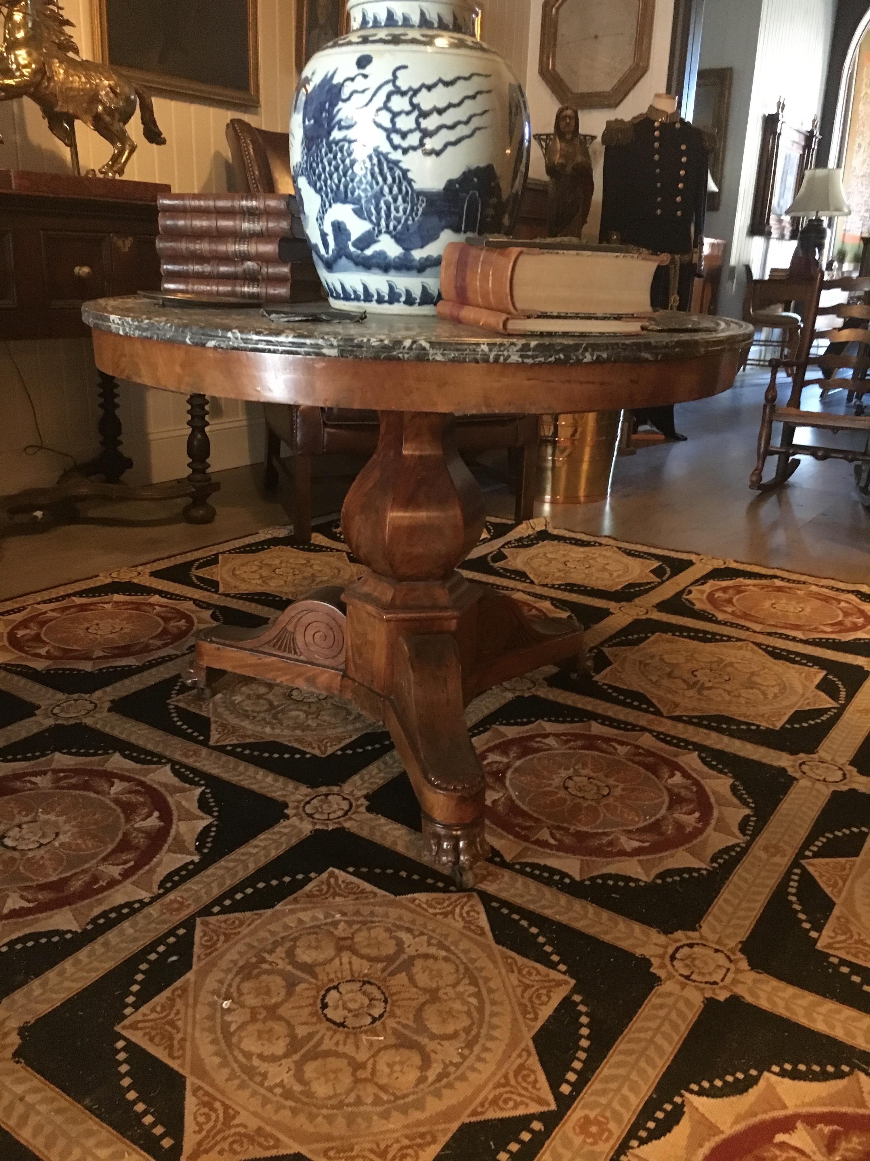 A Louis Philippe burl wood centre table measure: Height 28 3/4 x diameter of top 38 1/4 inches. Marble top over burl wood base.