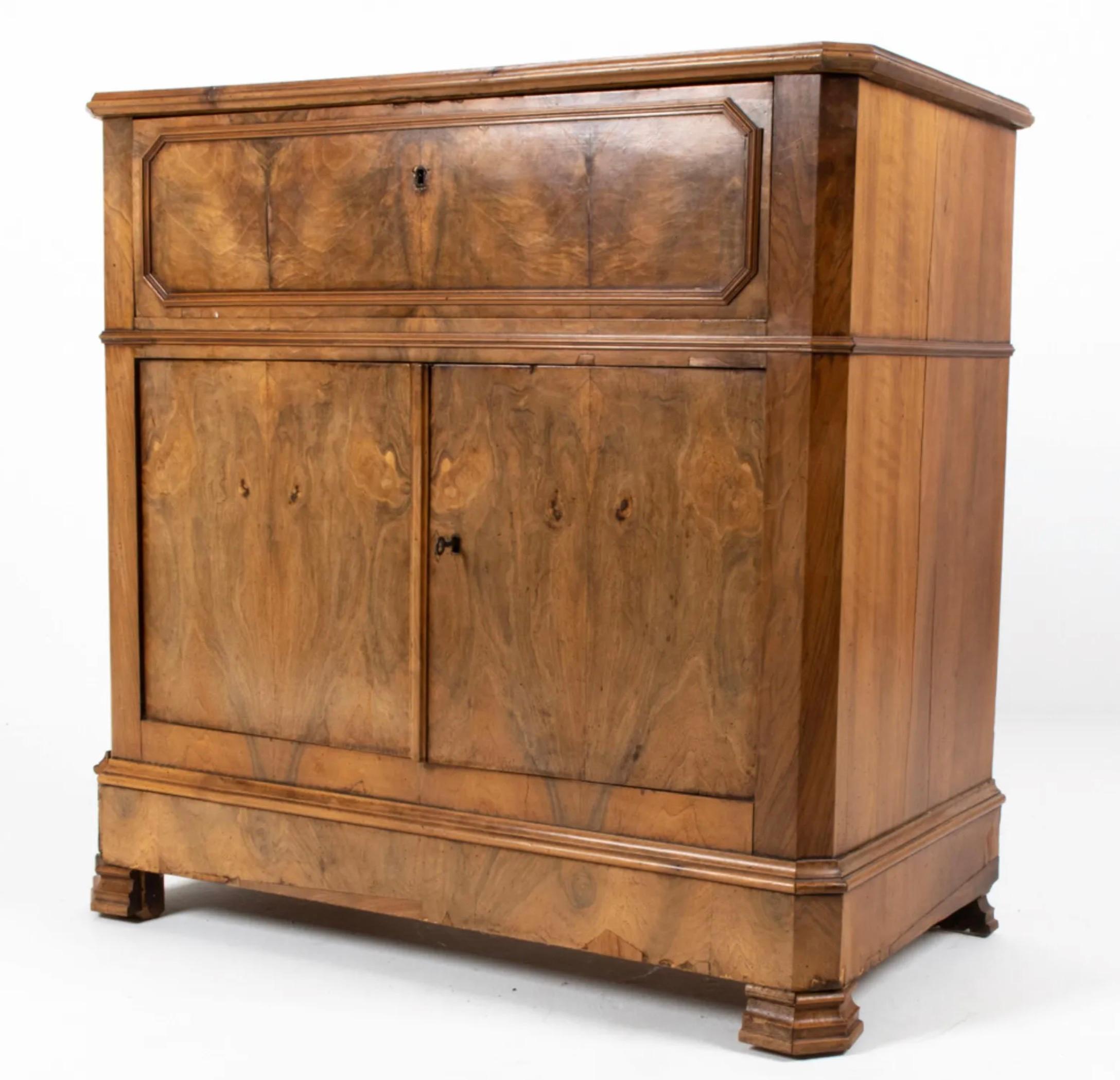 Unusual buffet cabinet with drop-front secretary, which opens to reveal birdseye maple drawer fronts with ebonized trim and an embossed leather writing surface. Dimensions: H 39.5