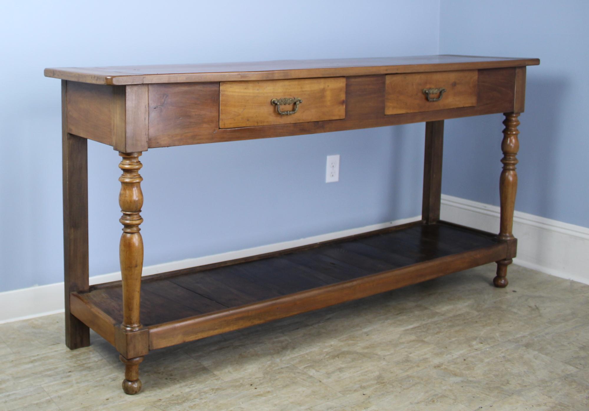 A lovely cherry potboard server, custom made for Briggs House in France with old legs, circa 1850. Generously proportioned with a thick top, two roomy drawers, and light mellow cherry color.