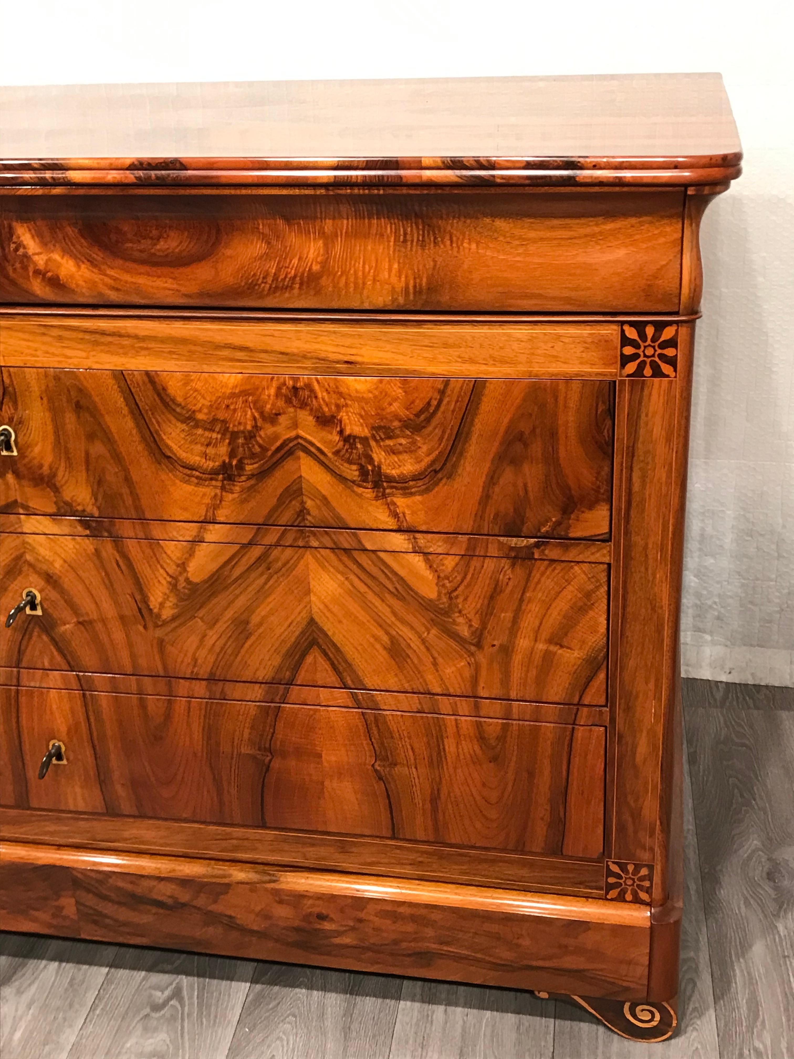 This Louis Philippe chest of drawers dates back to circa 1840 and was made in France. 
We can determine its place of origin because of a drop front desk which originally was probably made for the same owner as the chest and which has a gold embossed