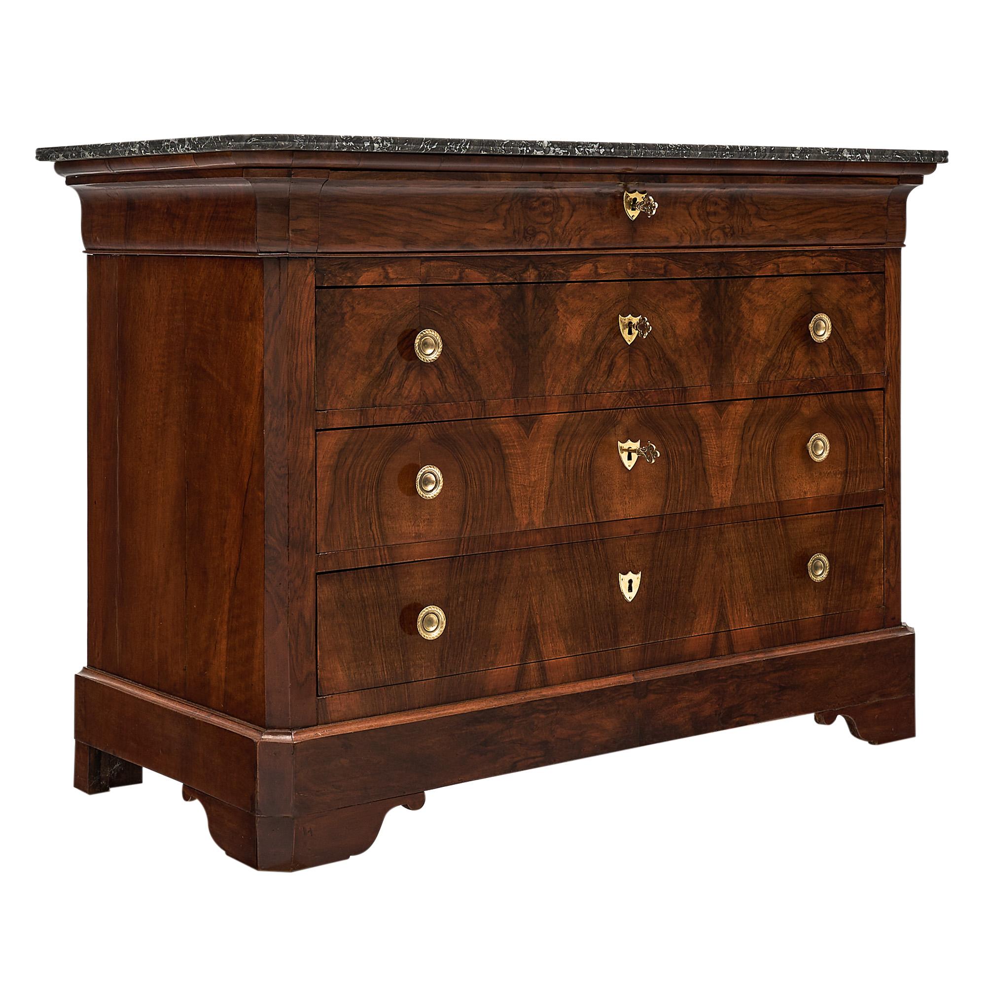 Chest, French, from the Louis Philippe period made of Cuban flamed mahogany. There are four dovetailed drawers, the top one being hidden in the “doucine” apron. Working locks and keys. There is an intact Sainte Anne marble slab top.
