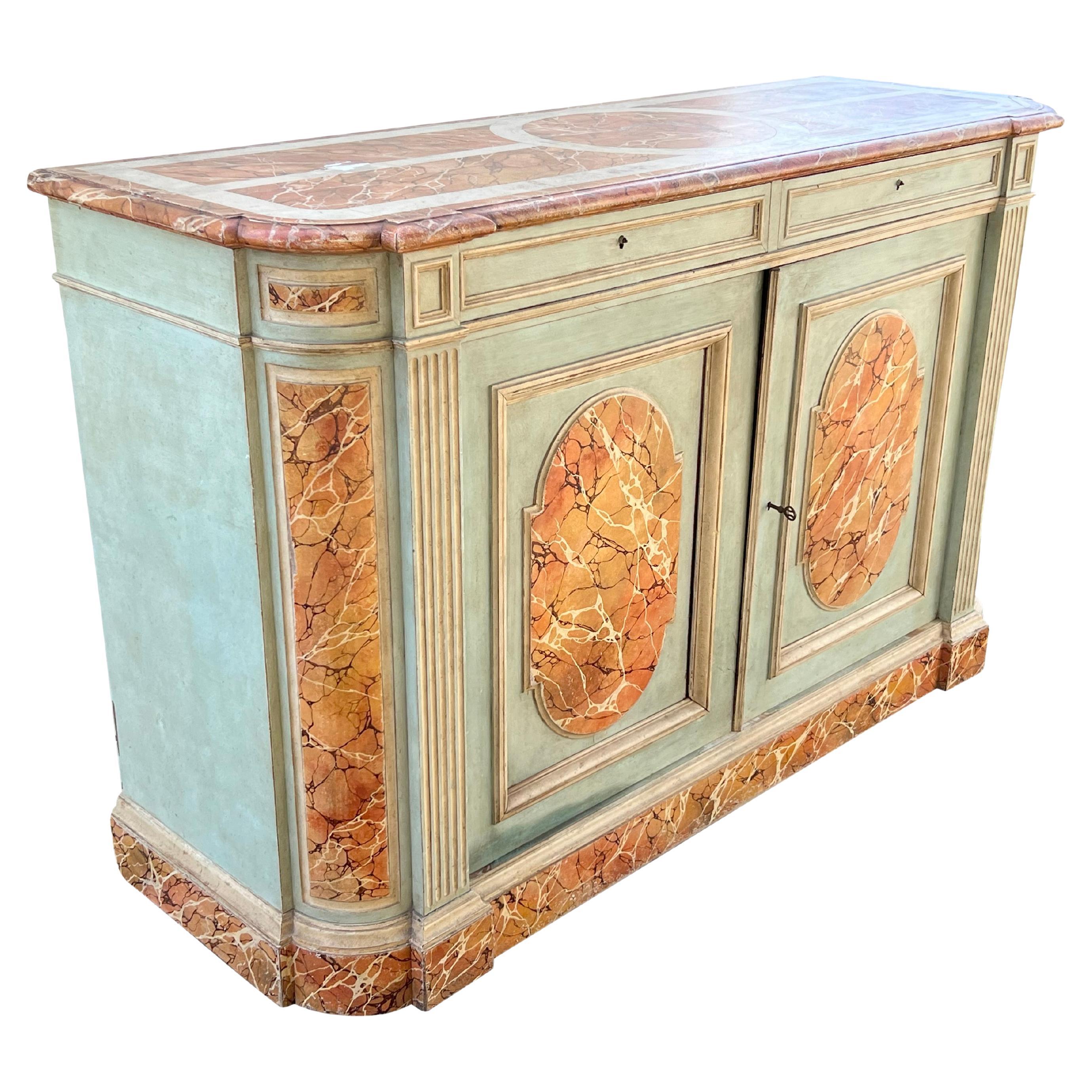 With rectangular top with rounded ends. Faux marble top over two drawers over a pair of cabinet doors. Plinth base.