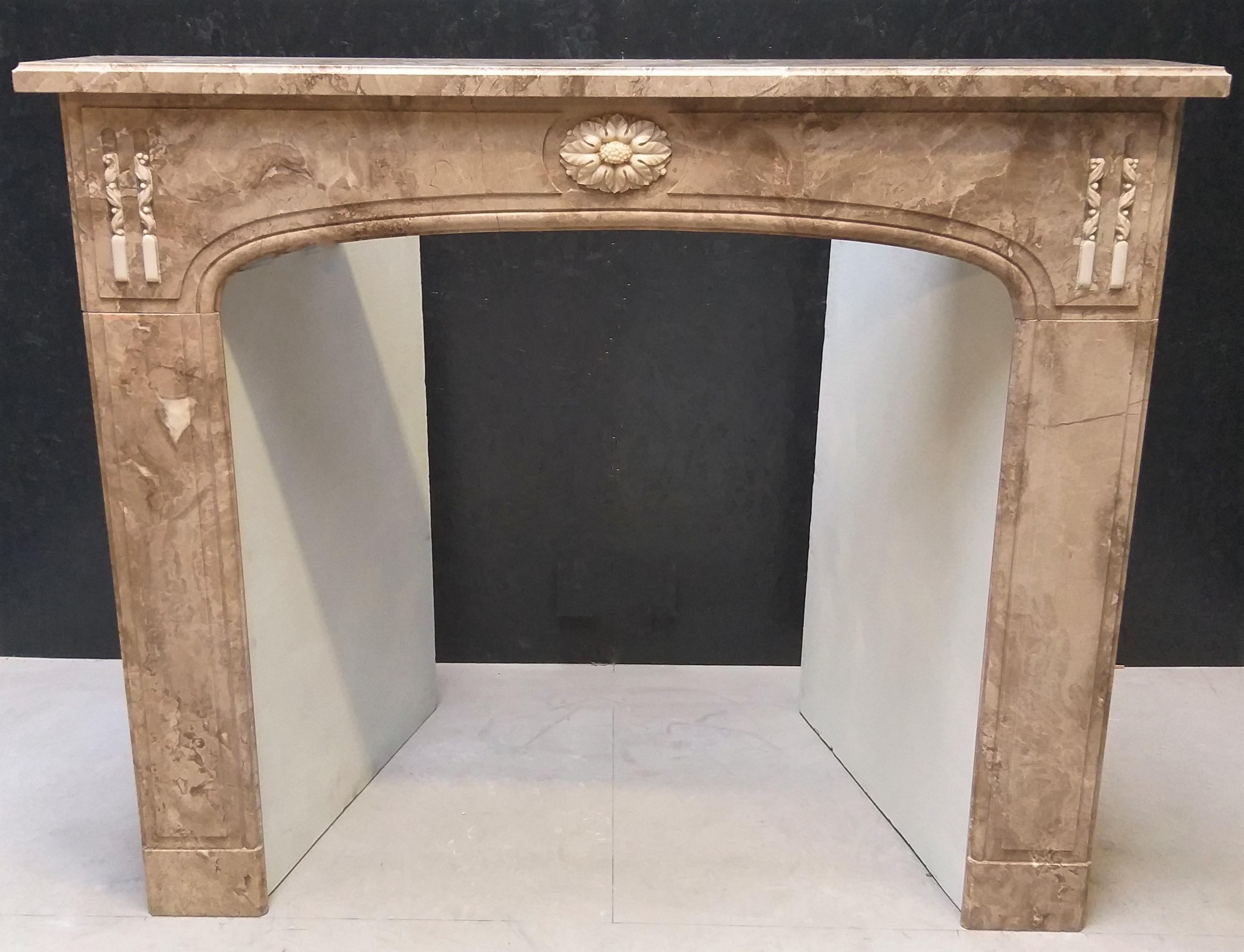 This charming antique fireplace was made out of the beloved, Italian marble Napoléon Grand Mélange, during the second half of the nineteenth century.  The center of the frieze has a nicely carved rozet of another Italian marble: Carrara.  The top of
