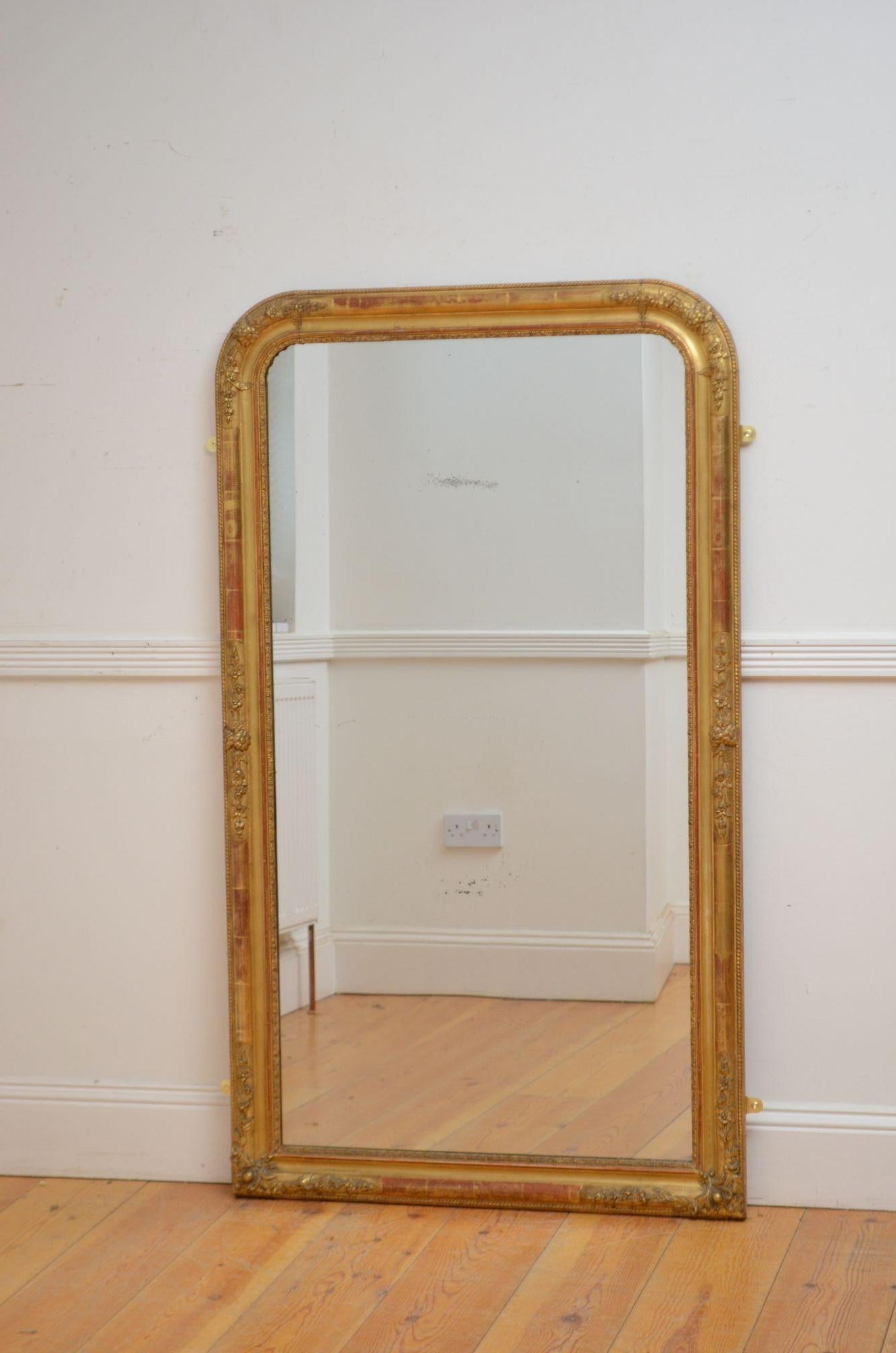 Sn5551 A large French gilded wall mirror of arched form, having original glass with some foxing in moulded and carved gilded frame with carved floral decoration throughout. This antique mirror retains its original glass, original gilt and original