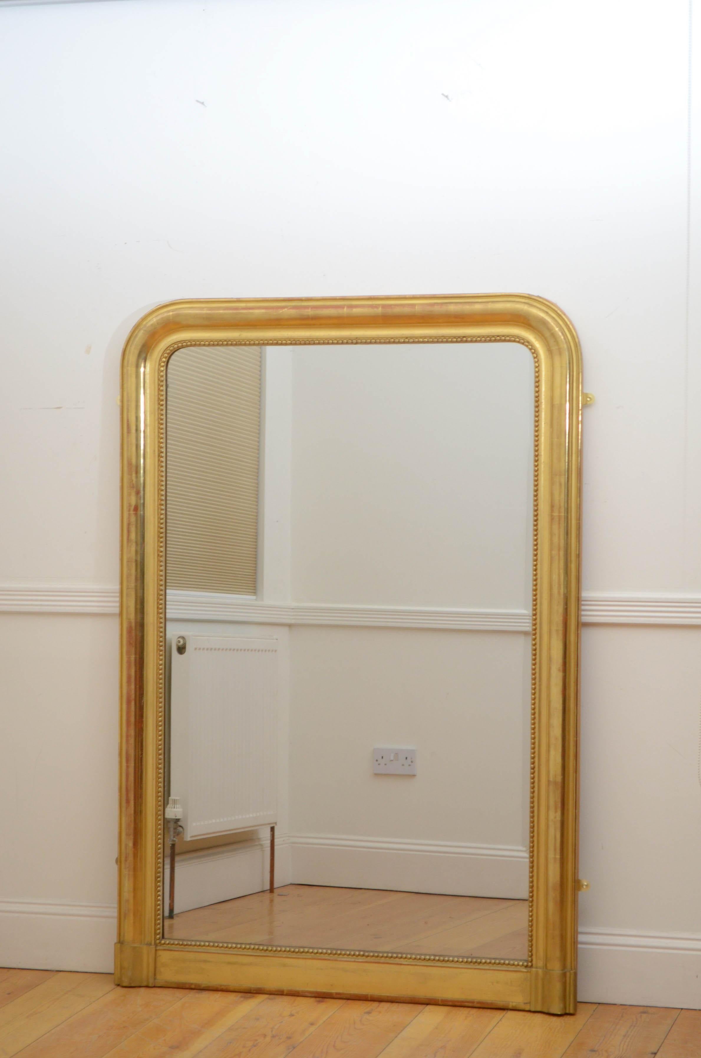 Sn5208 Fine Louis Philippe mirror giltwood wall mirror, having original foxed glass in beaded and moulded gilded frame with arched top corners. This antique retains its original glass, gilt and backboards, all in wonderful home ready condition.