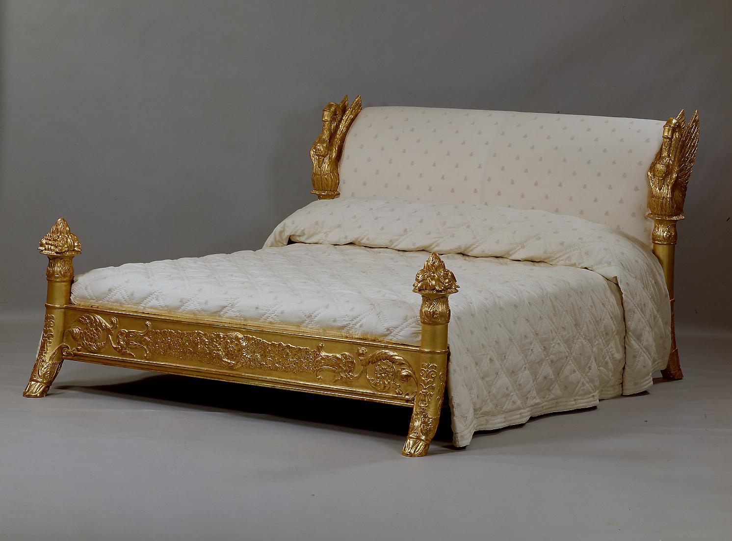 A Majestic Louis-Philippe Giltwood and Gilt Composition King Size Bed, after a model by Francois-Honoré-Georges Jacob-Desmalter, the outwardly curved headboard flanked by two open-winged swans on foliate cornucopia supports ending in hoof-feet, the