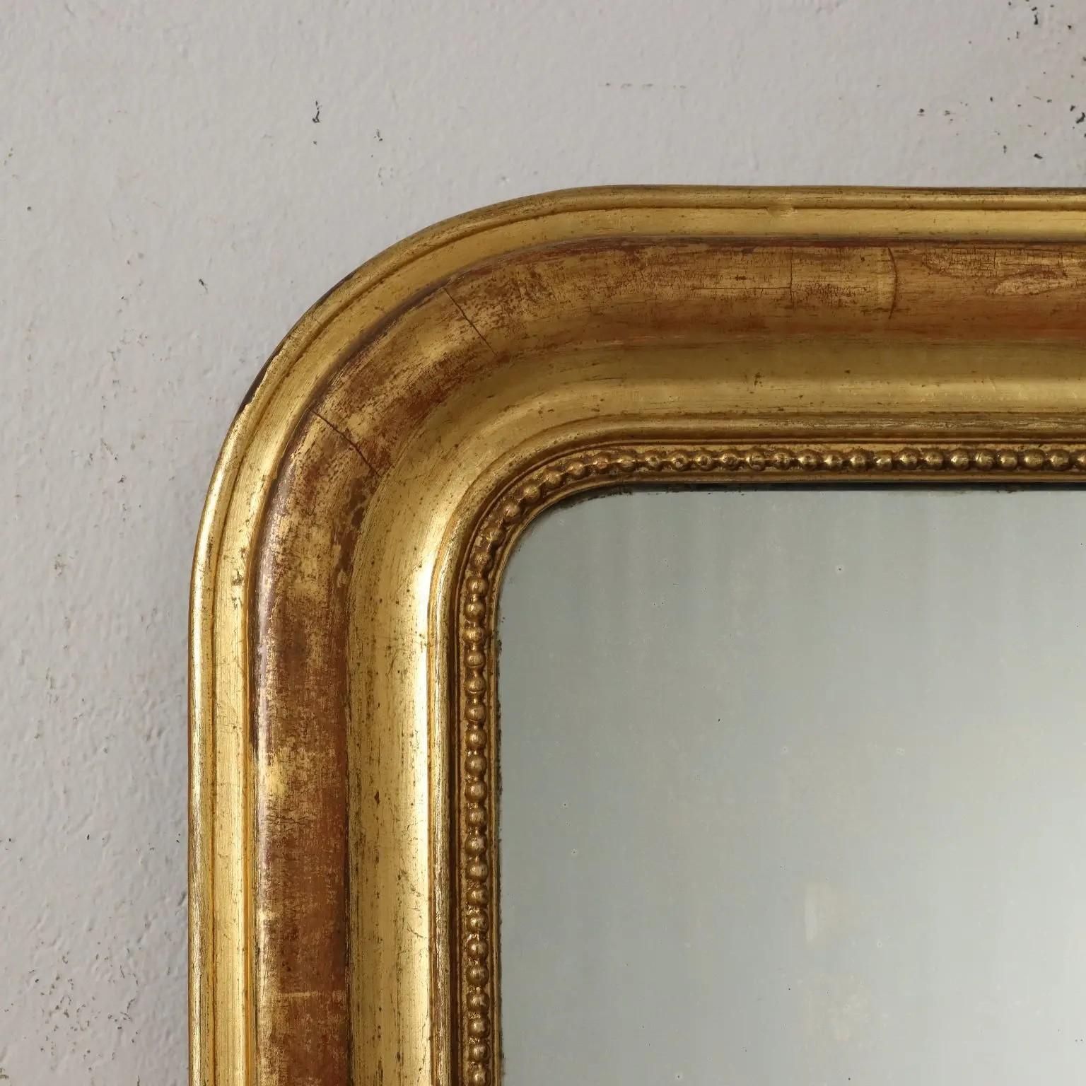 The arched rectangular plate within a molded giltwood border