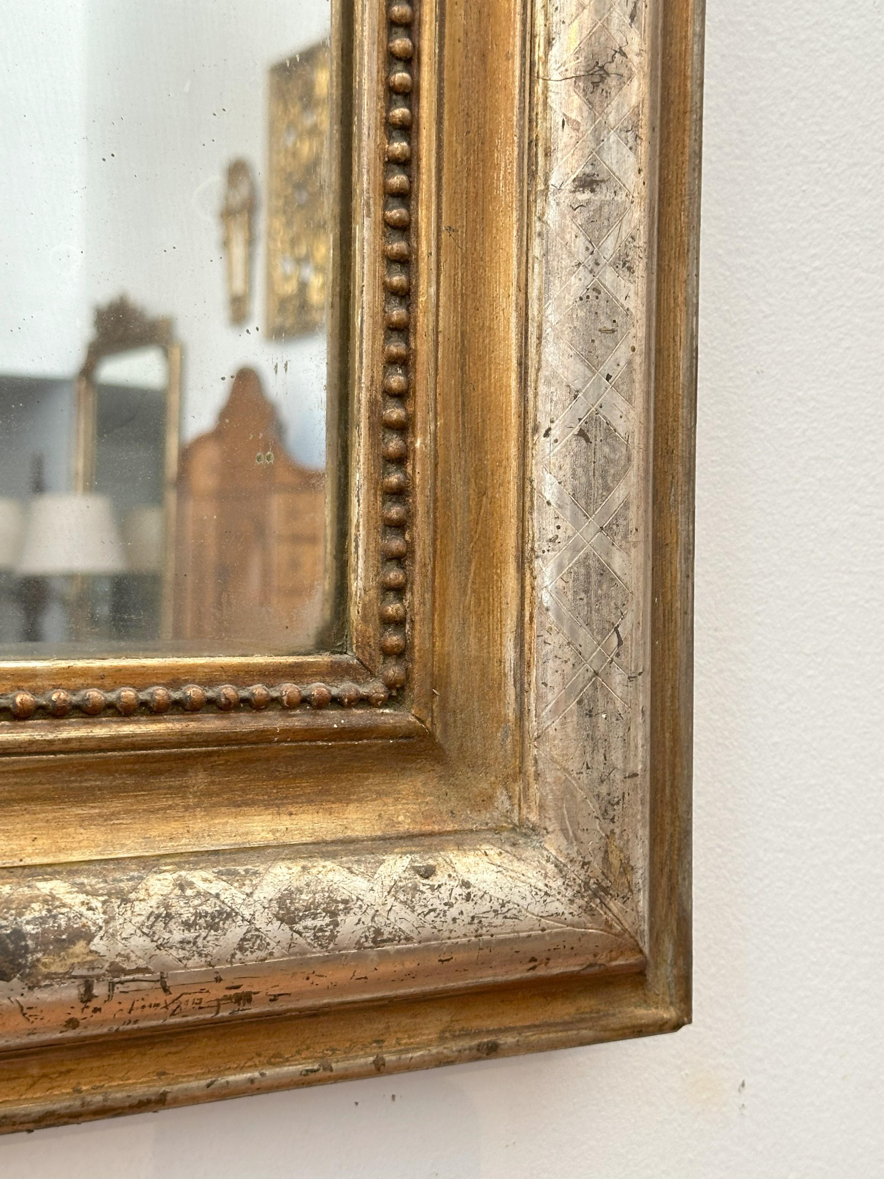 The arched rectangular plate within a molded giltwood border 