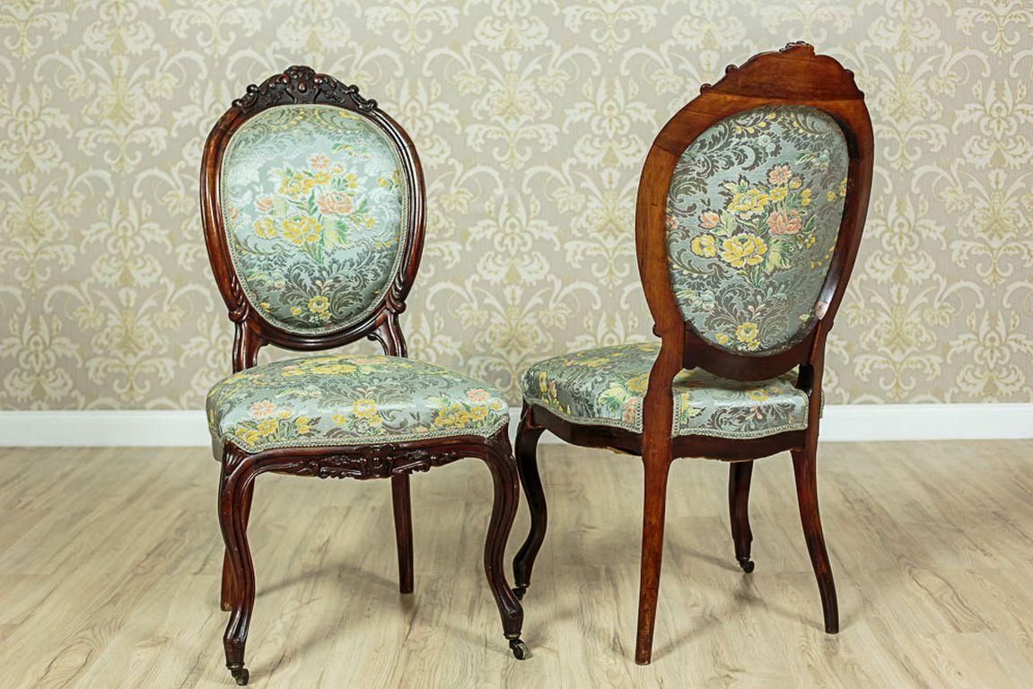 We present you these two wooden chairs with upholstered seats and backrests.
The fronts legs are bent and end with brass circles.
The armchairs’ frames are ornamented with fluting and a semi-plastic, decorative woodcarving at the bottom of seats,
