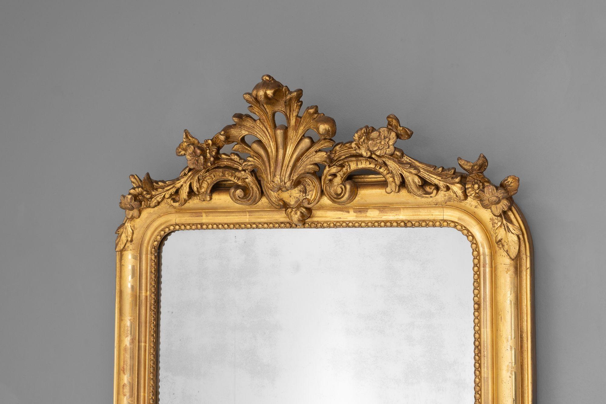 Gilded Louis Philippe mirror with crest decoration and original split mirror plate. France circa 1880.

H 178cm x W 72cm x D 18cm

Please be in touch for an accurate shipping quote.