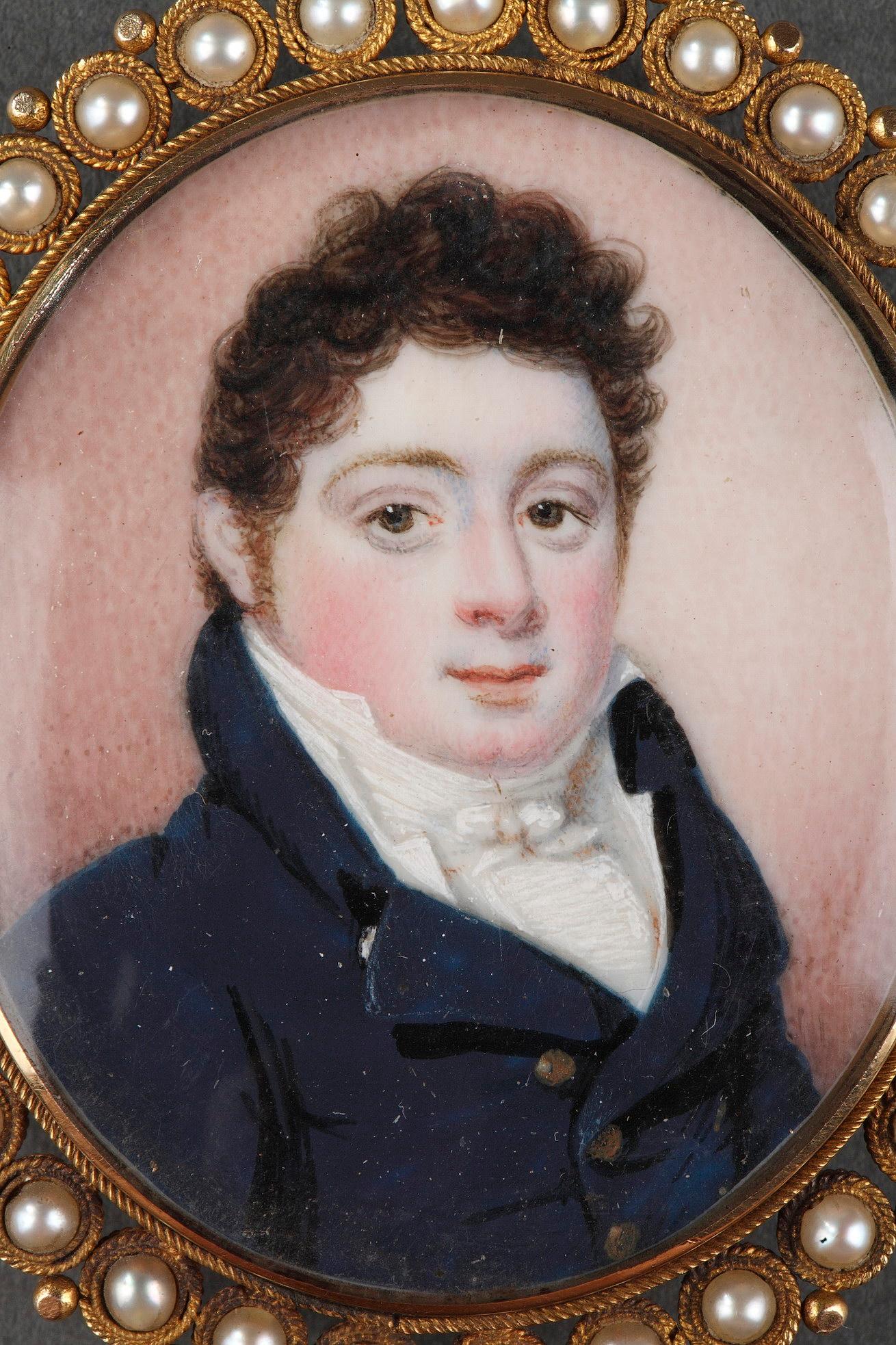 A gold-mounted pendant with a mother-of-pearl medallion depicting the portrait of a young dandy on light pink background, framed with pearls. On the back, locks of hair attached with fine pearls and monogram 