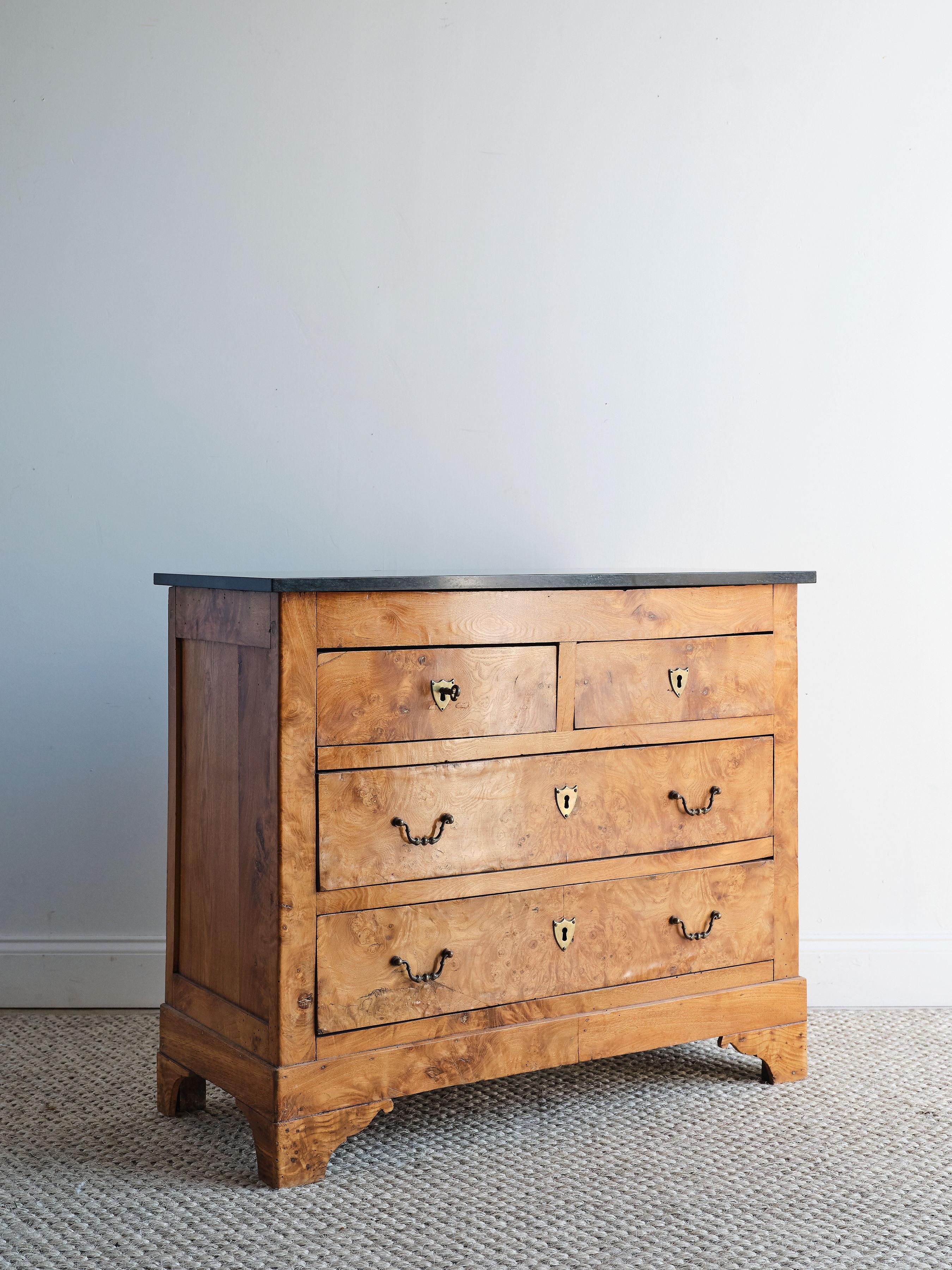 A French burled beauty! This stunning Louis Philippe chest features a dark grey marble top and beautiful walnut burled wood. There are two small top drawers and two large bottom drawers with working locks and key. All of the hardware is original