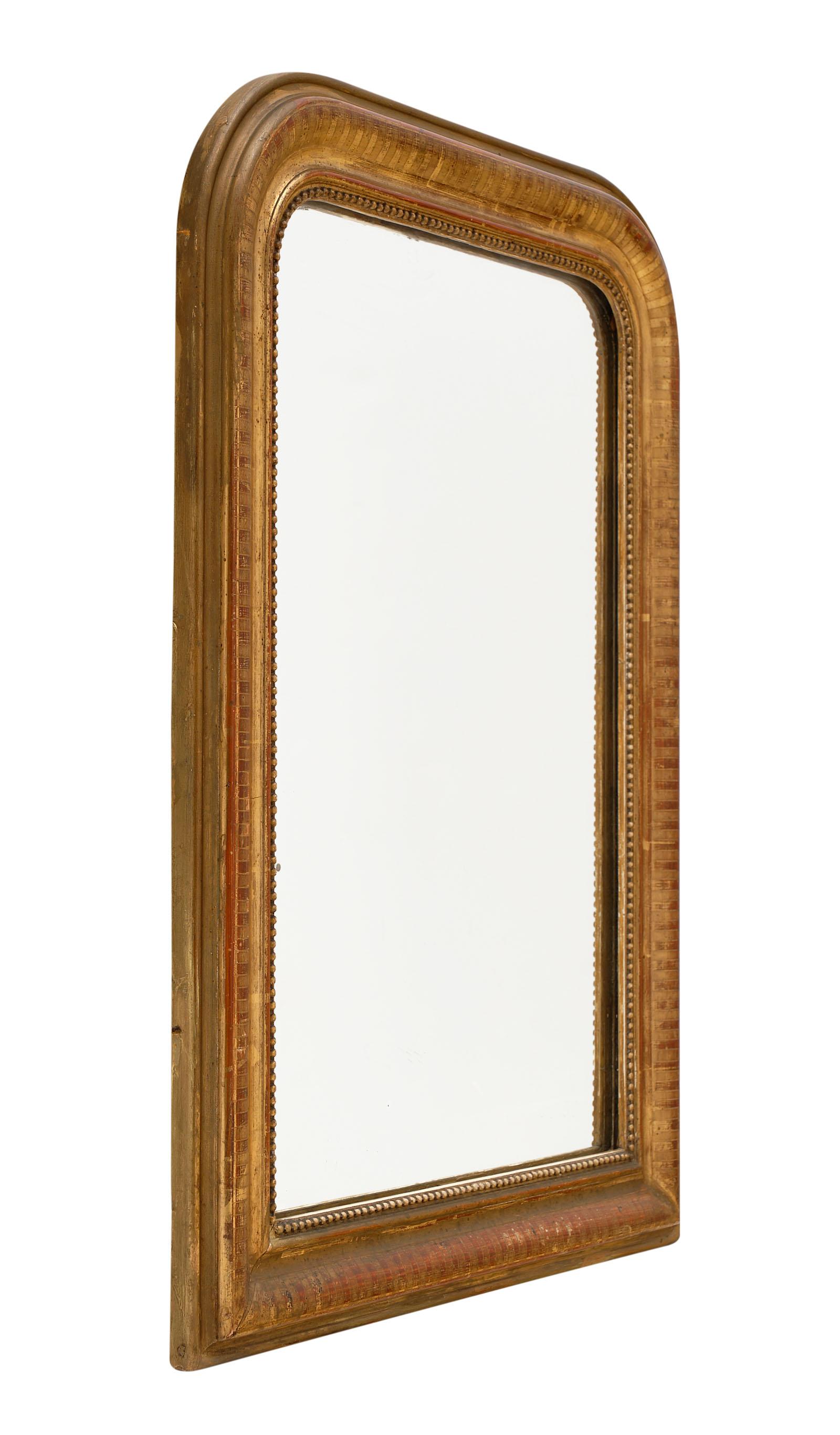 Louis Philippe period gold leaf mirror from the south of France with a beautiful hand-chiseled wood and gesso frame. The gold leaf has a beautiful patina and the sienna colored glaze shows through for a warm and inviting impact.
