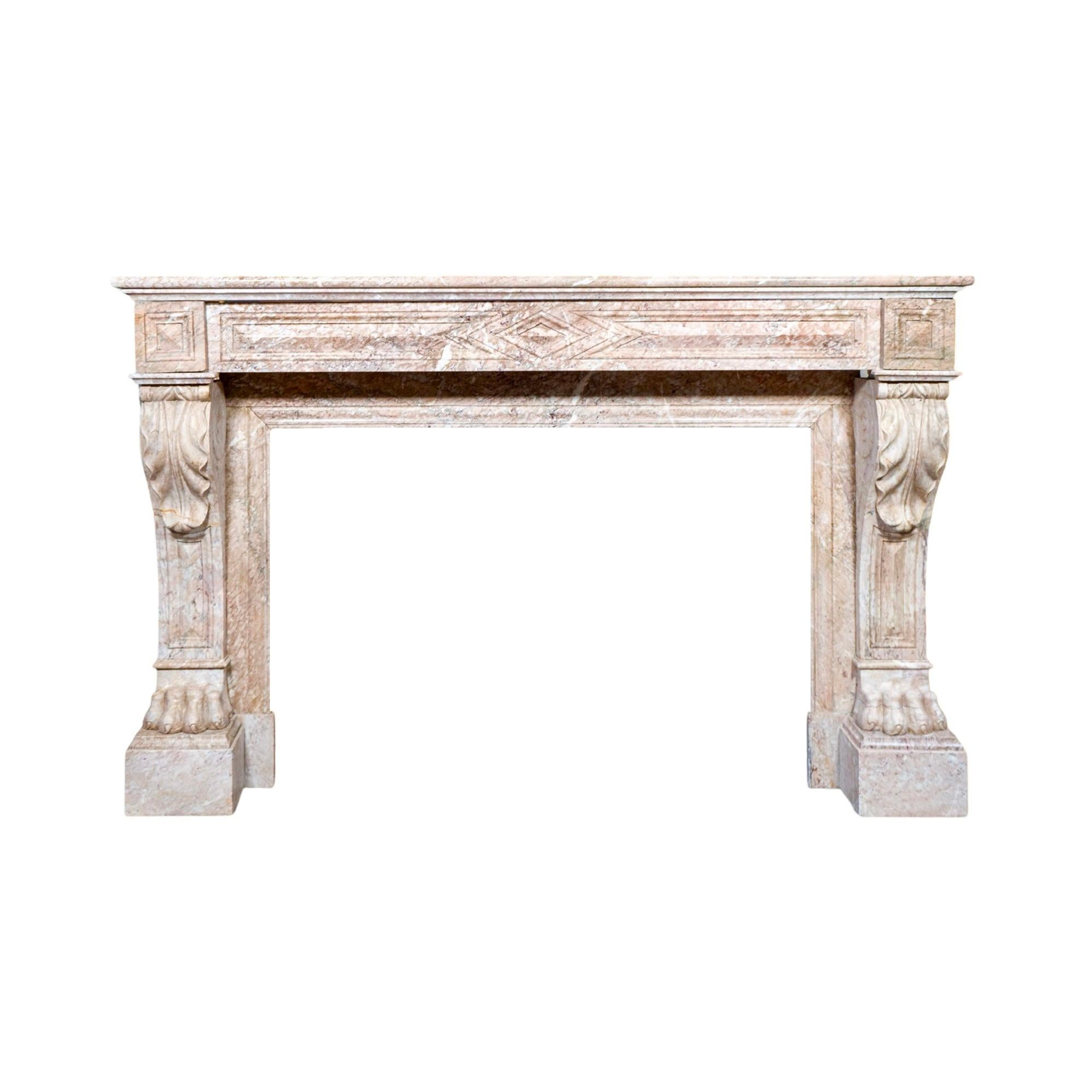 This antique French mantel, crafted from Balacet marble in the 1880s, showcases exquisite Empire-style design and exceptional craftsmanship. The centerpiece features a hand-carved geometric triangular motif on the keystone, adding a striking focal