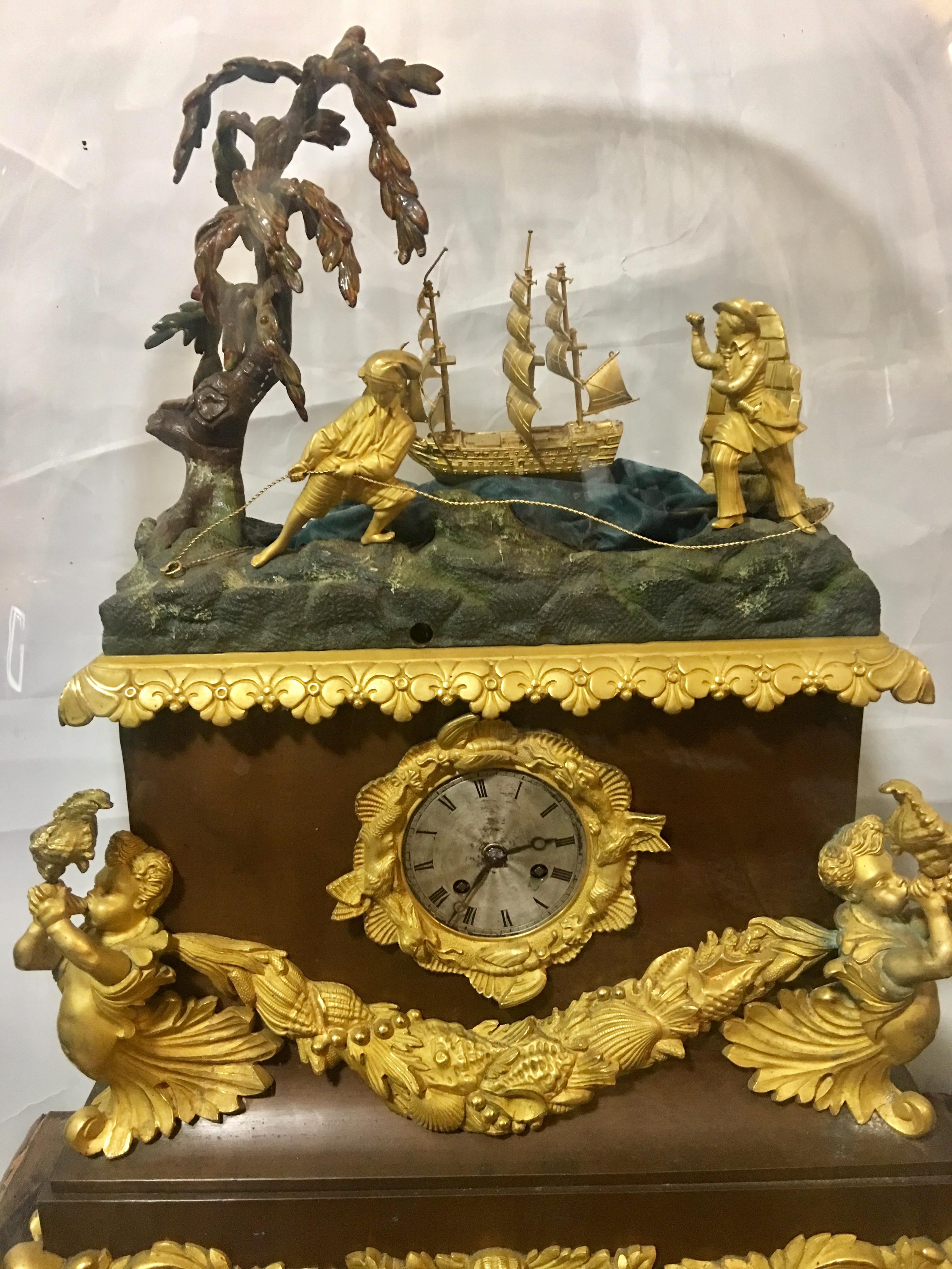 A Louis Philippe ormolu, bronze and copper automaton clock,
circa 1840.

The case of shaped rectangular outline, the top modelled with a maritime scene of two sailors and a ship rocking on the seas, with a polychrome painted tree, above the