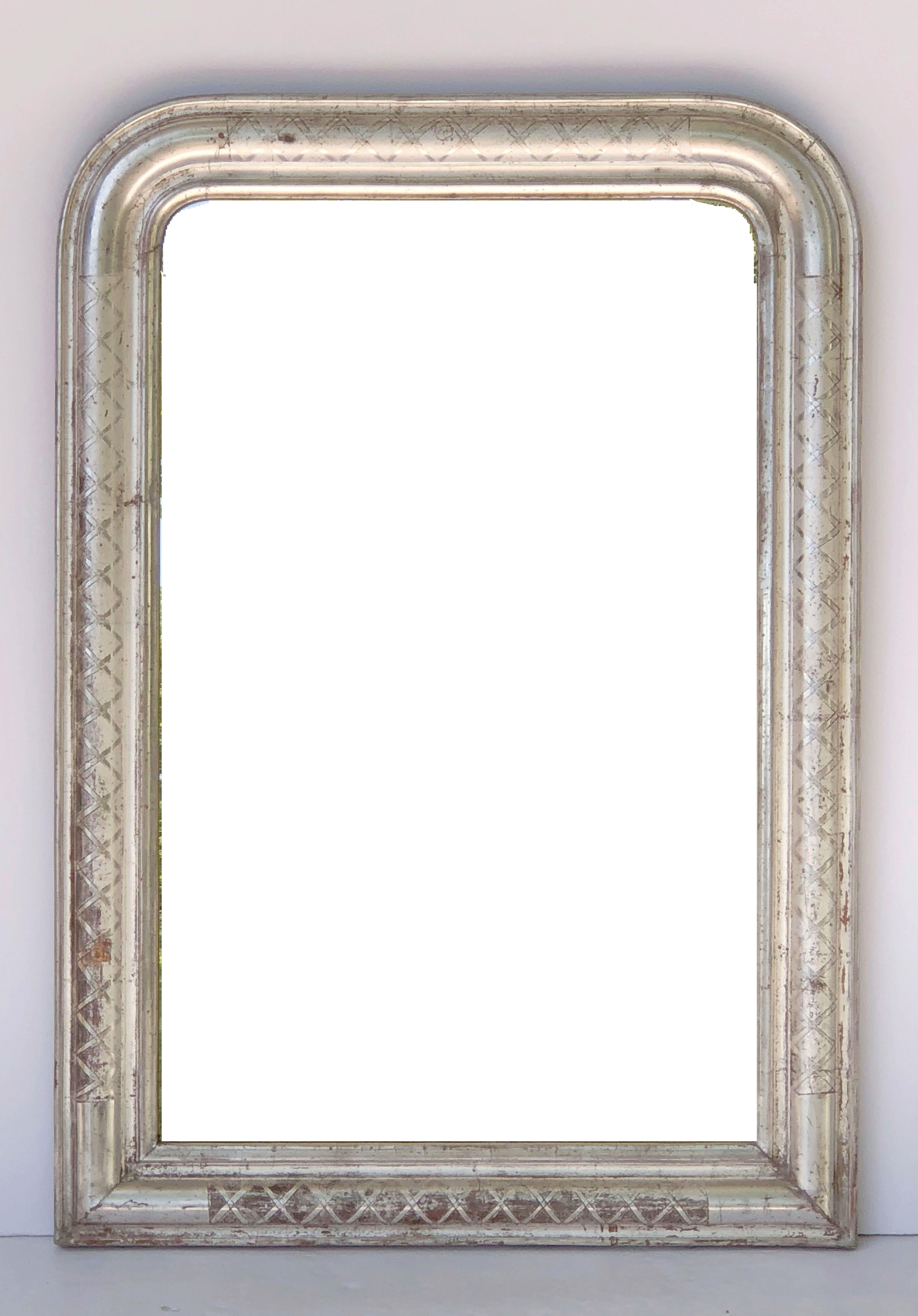 A fine Louis Philippe wall mirror from France, featuring a moulded surround with a beautiful patinated silver-leaf.

Dimensions: H 35 inches x W 24 3/4 inches

Other sizes available in this style.