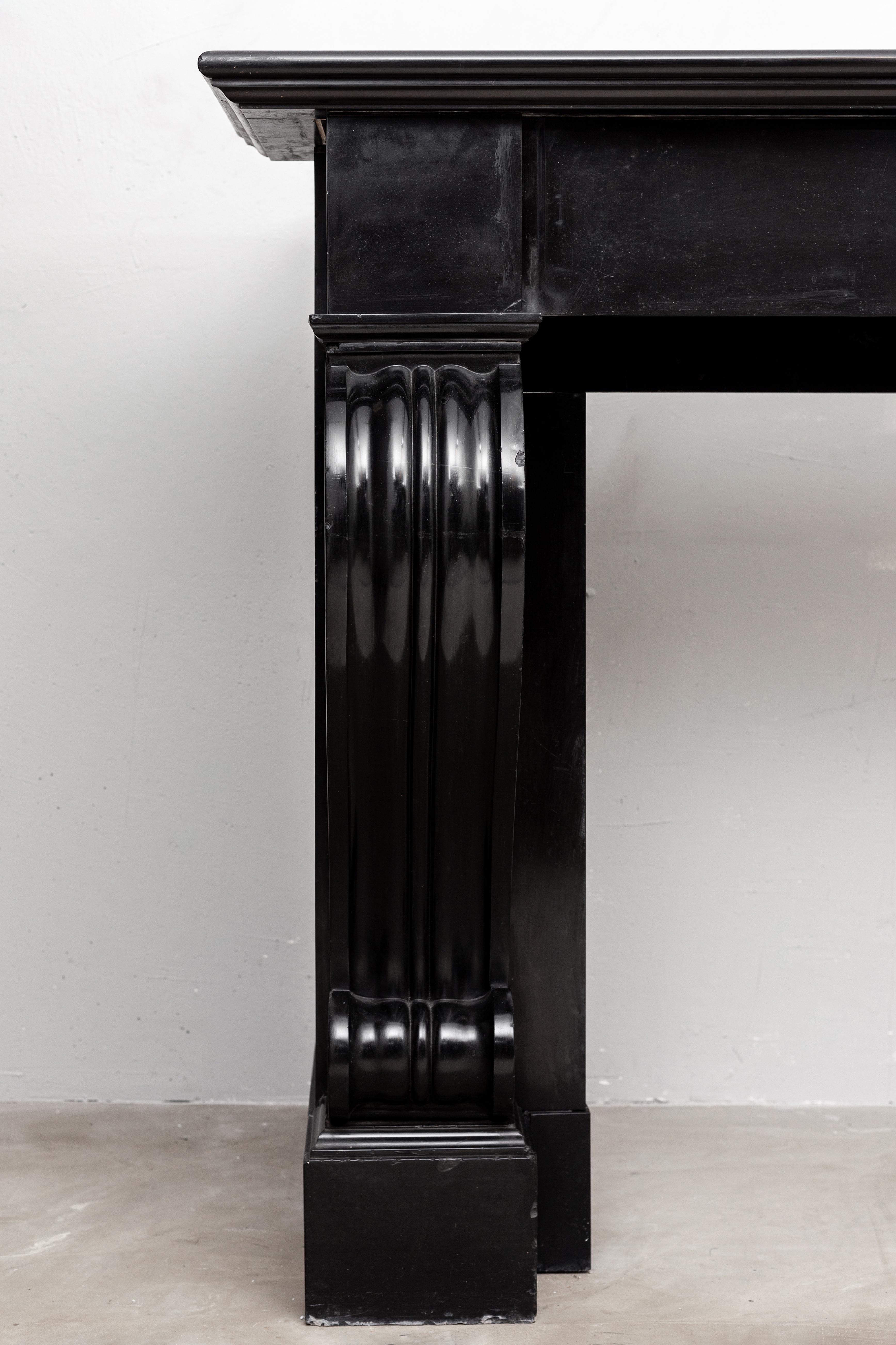 This Louis Philippe fireplace comes straight from a Utrecht canal house. The allure radiates from it and the Noir de Mazy version makes it a showpiece.
The heavy solid consoles have beautiful profiling on the front and both sides, which gives the