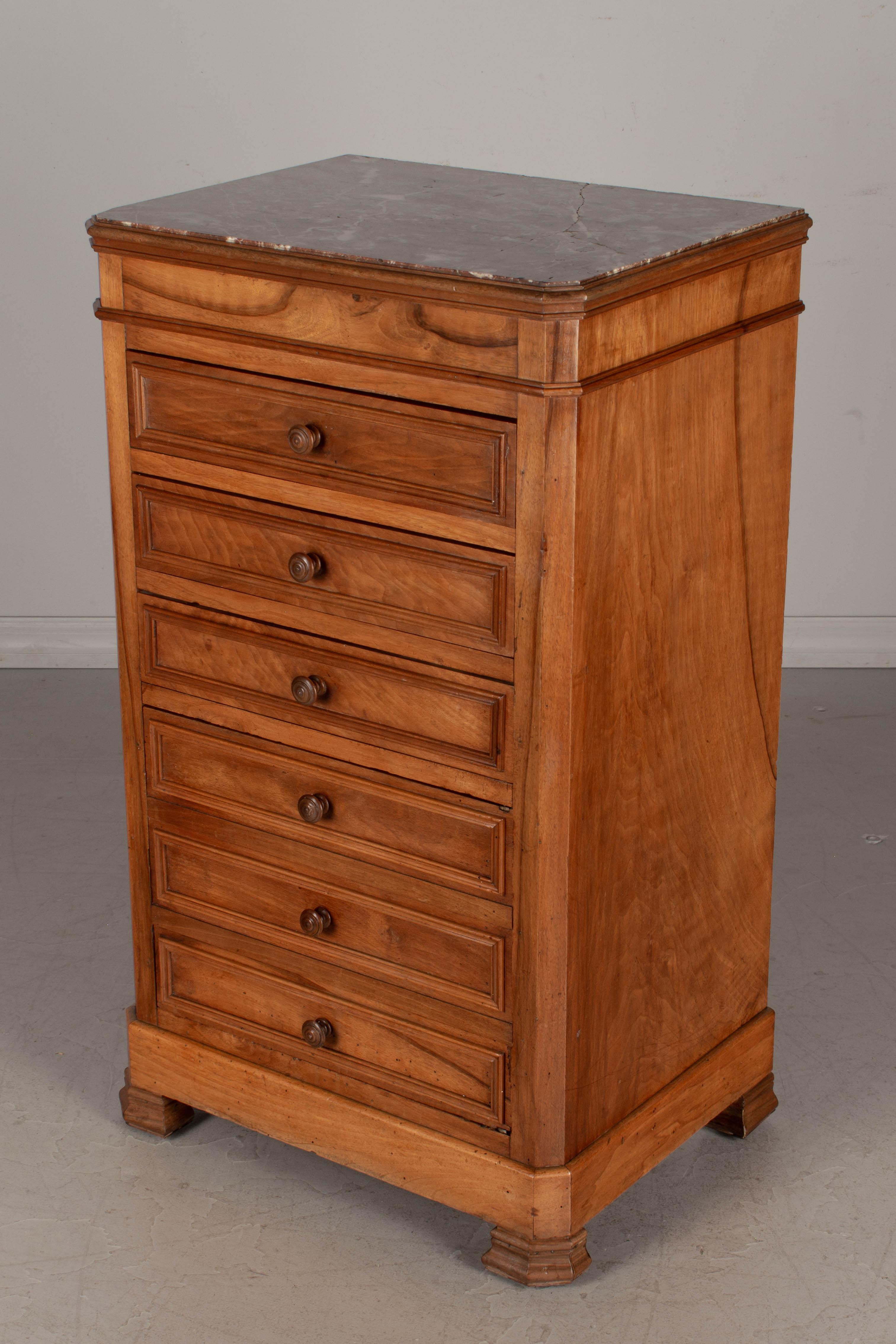 A French Louis-Philippe style coffre fort, or stand with hidden safe. Made of walnut veneer with inset marble top. Three dovetailed drawers with a false front cabinet below. Concealed safe is in working order with key and combination lock. Bauche