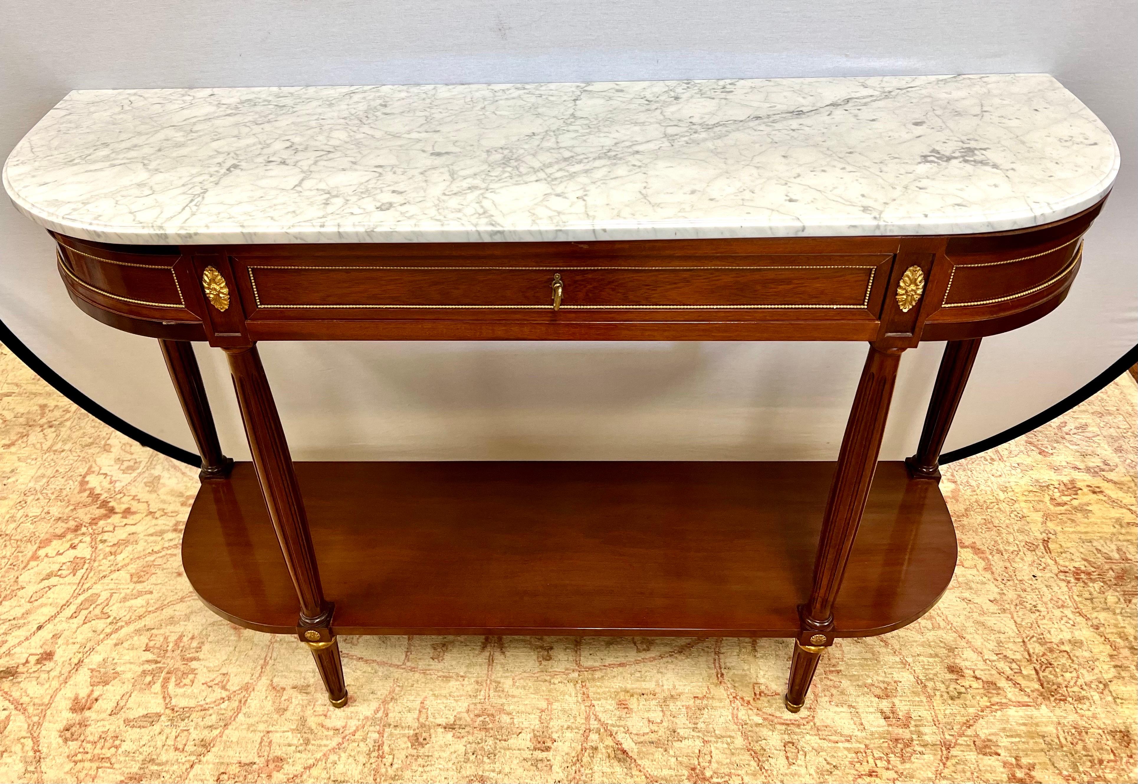 Elegant mahogany server with grand marble top. Note there is a minute chip at top of marble that is hardly noticeable and does not detract at all. Great scale and better lines. Features two tiers that allows for more storage. Would make a wonderful