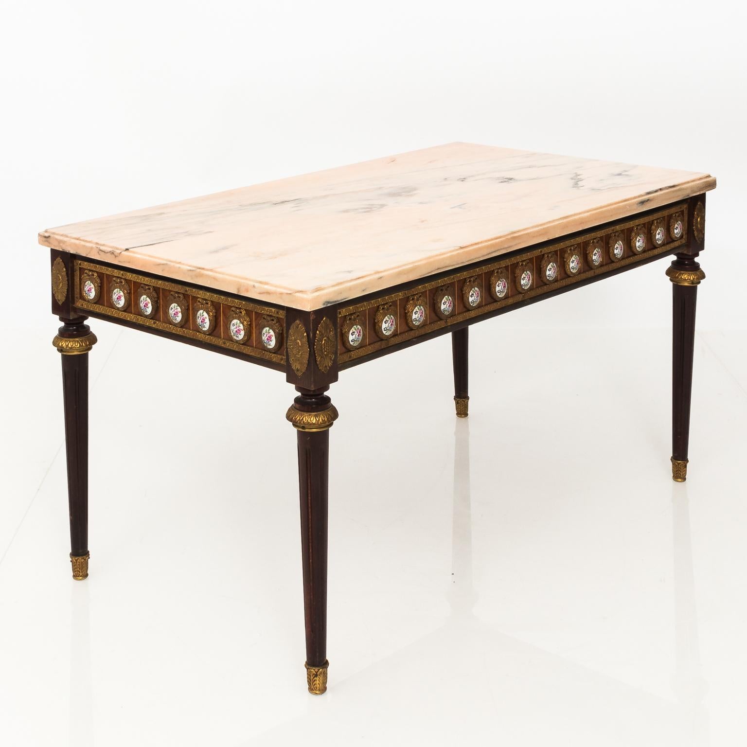 Louis Philippe style marble-top console table with bronze mounts and porcelain painted flower inserts, circa early 20th century. Signed on the base.