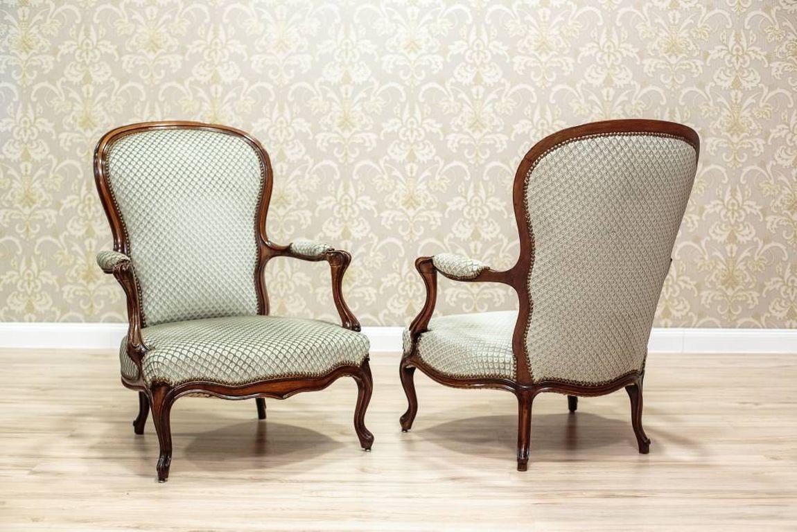 This suite represents shapes typical for the Louis Philippe style. The suite includes two broad armchairs with arms, and two chairs. The profiled backrests of the furniture have upholstered backs and fronts. The seats are spring. The upholstery has