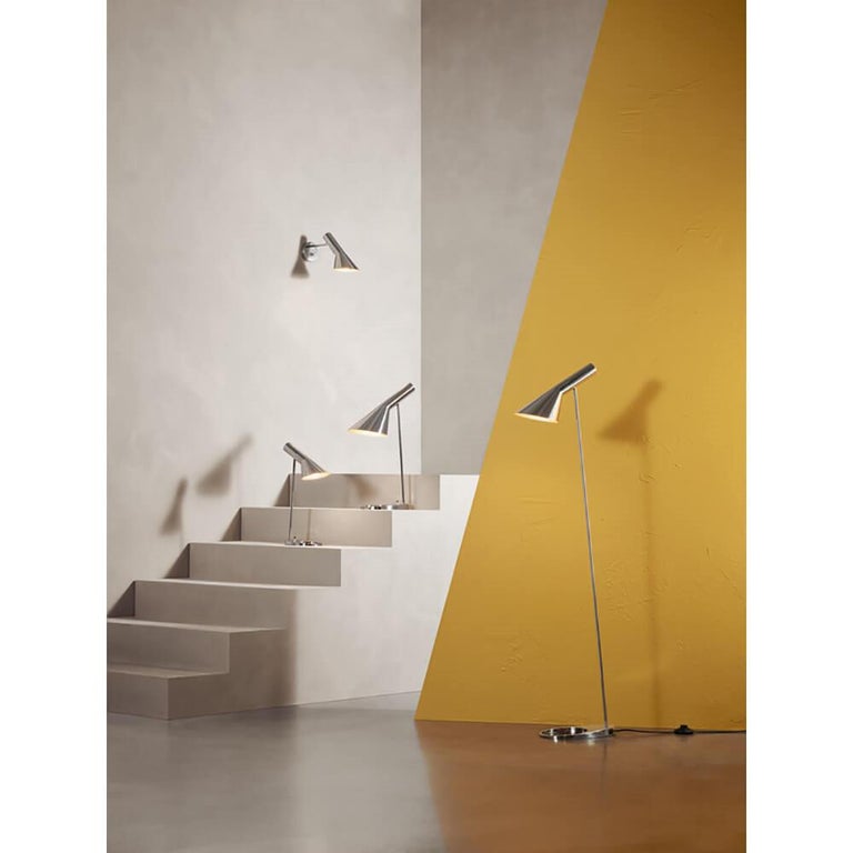 Louis Poulsen, AJ steel wall lamp by Arne Jacobsen
Measures: Width 318 x height 180 x length 125(mm), 0.9 kg

Material: Stainless steel, polished. Cord length: 2.4 m. Switch: On the rear housing. Cord type: Black plastic with plug. The angle of