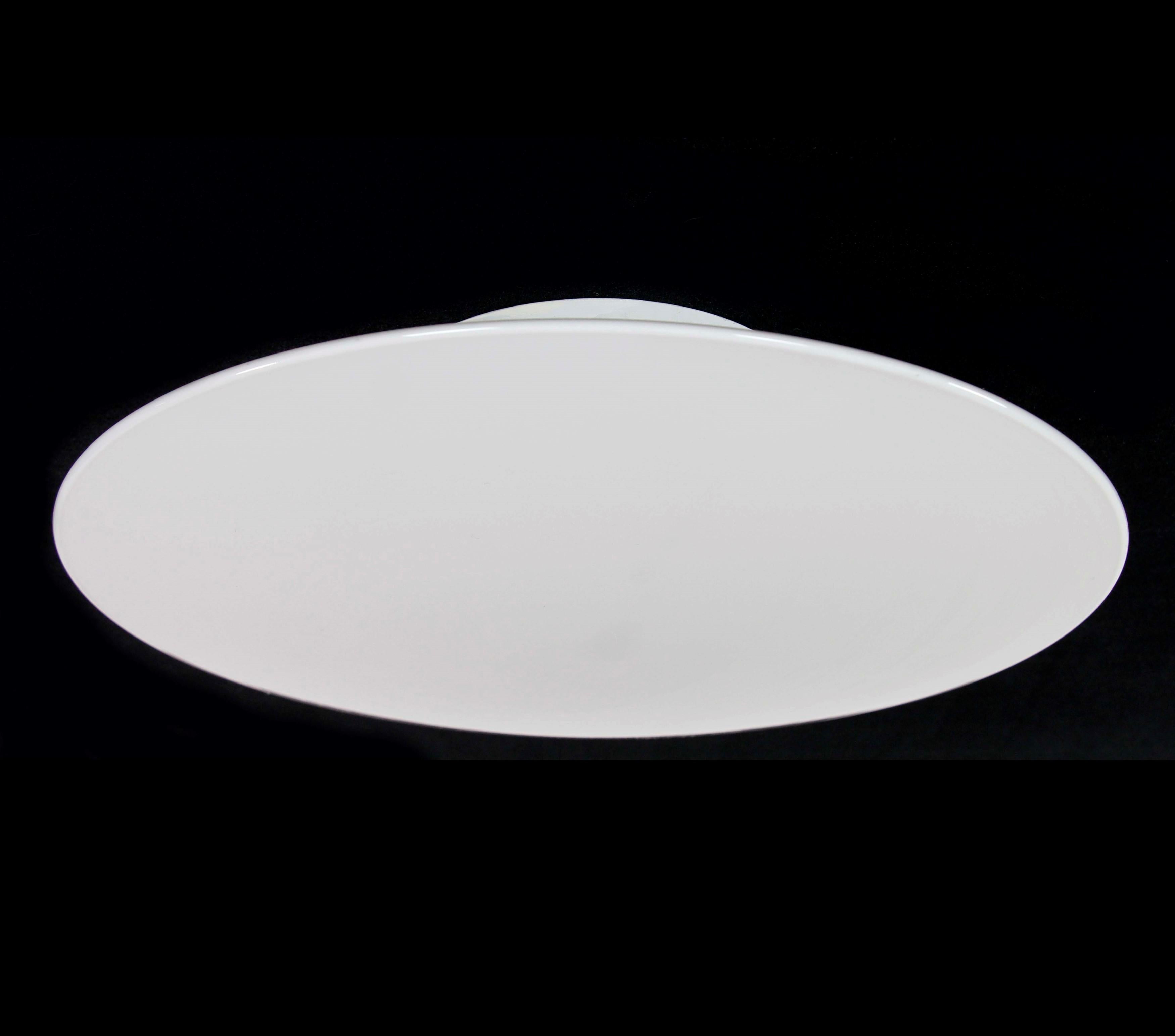 This European flush mount light captures minimalist elegance. With a round white glass shade, it embodies contemporary European design. This flush mount light adds a touch of modern sophistication to spaces, providing functional illumination while