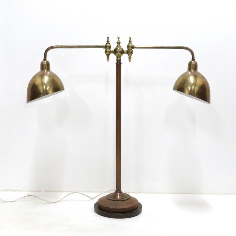 Large-scale articulate double arm desk lamp by Tvermoes & Abrahamson, Denmark with brass shades by Louis Poulsen in patinated brass with copper, turned wood and iron base, in-line on/off switch, wired for US standards, two E26 sockets, max. wattage