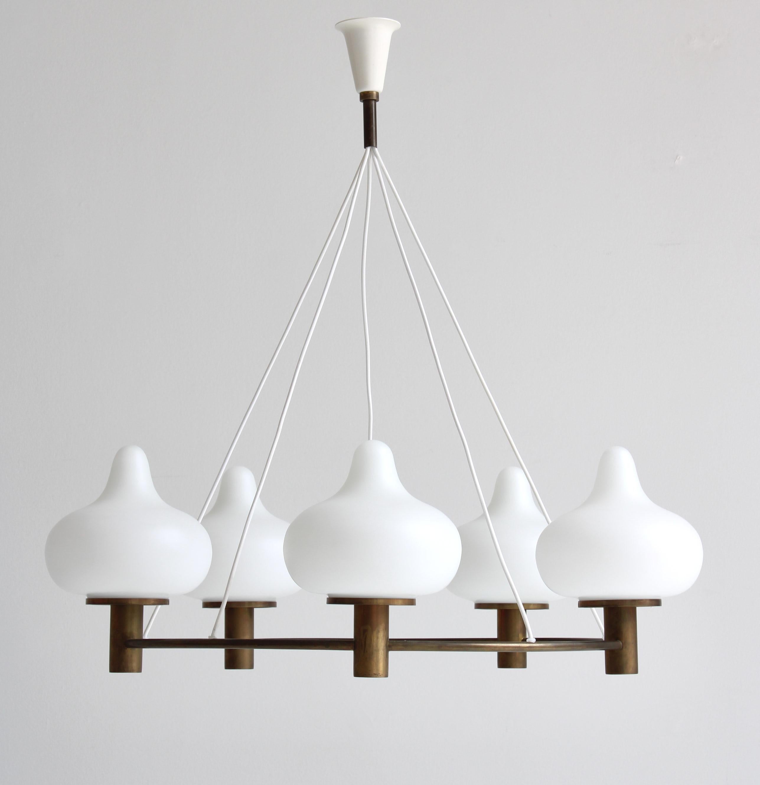 Rare and important ring chandelier designed in Denmark in 1953 by Mogens Hammer & Henning Moldenhawer for Louis Poulsen. The ring is made from beautifully patinated brass and the onion-shaped shades of hand blown matte opaline glass. This design was