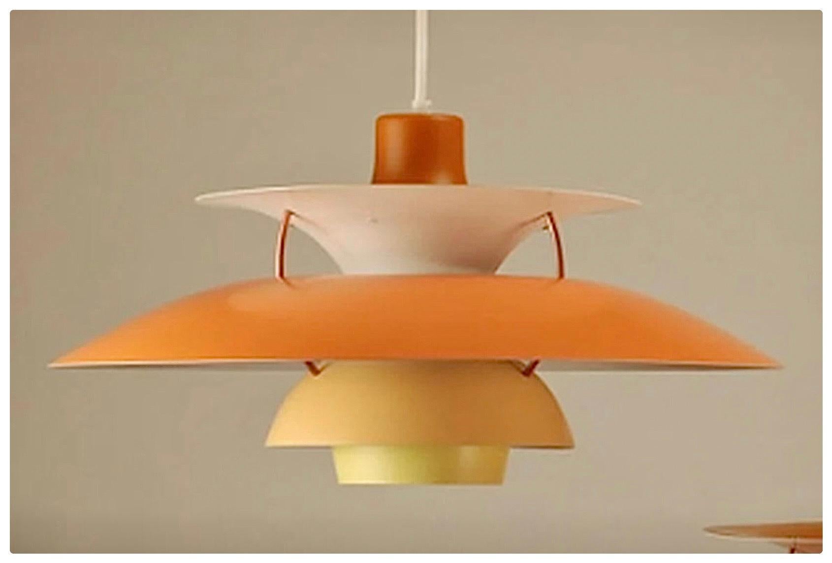the little sister of the Louis Poulsen PH5, in a contemporary version
Orange on the outside, with crème and light blue accent inside
The different metal layers provide a nice play of light and shadow- also on the adjacent walls and or ceiling. 

