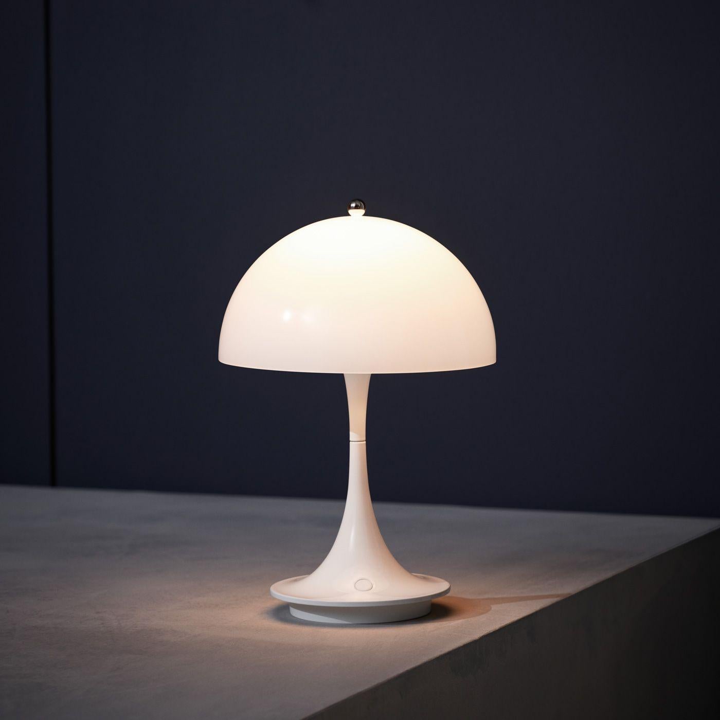 Louis Poulsen, portable table lamp by Verner Panton
Width x Height x Length (mm)
160 x 230 x 160, 0.5 kg
Finish: White opal acrylic Material: Shade: Injection moulded opal acrylic Base: Die cast aluminium Battery: Li-Ion Cable length: 1.5m.
